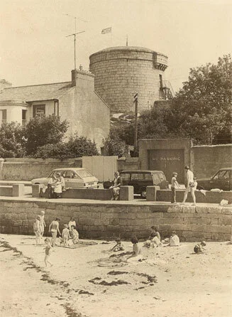 A press photo of the Sandycove tower in the 60's or 70's. You can see a staircase on the right side.