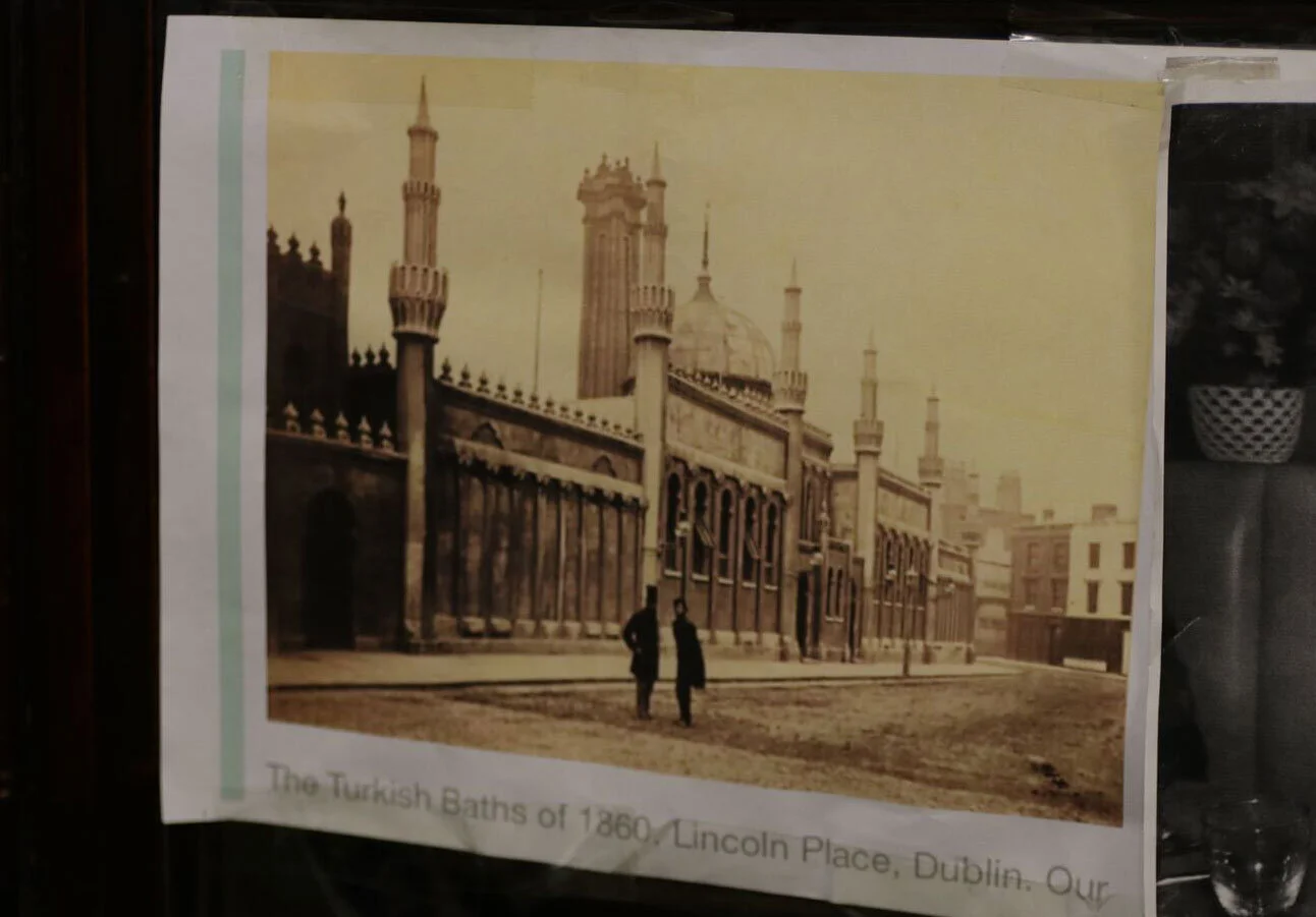 A photo of the former Turkish baths in Lincoln Place, Dublin hangs in Sweny's.