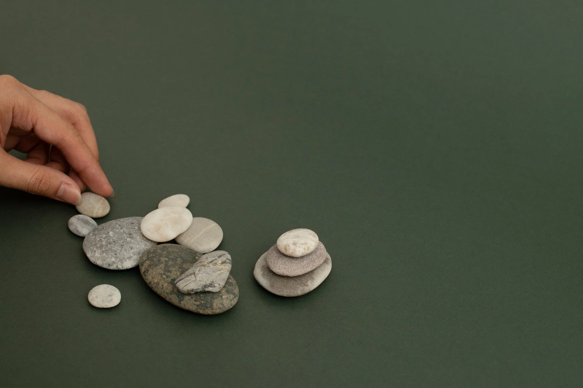 hand-stacking-zen-stones-sand-wellness-background-5.jpg