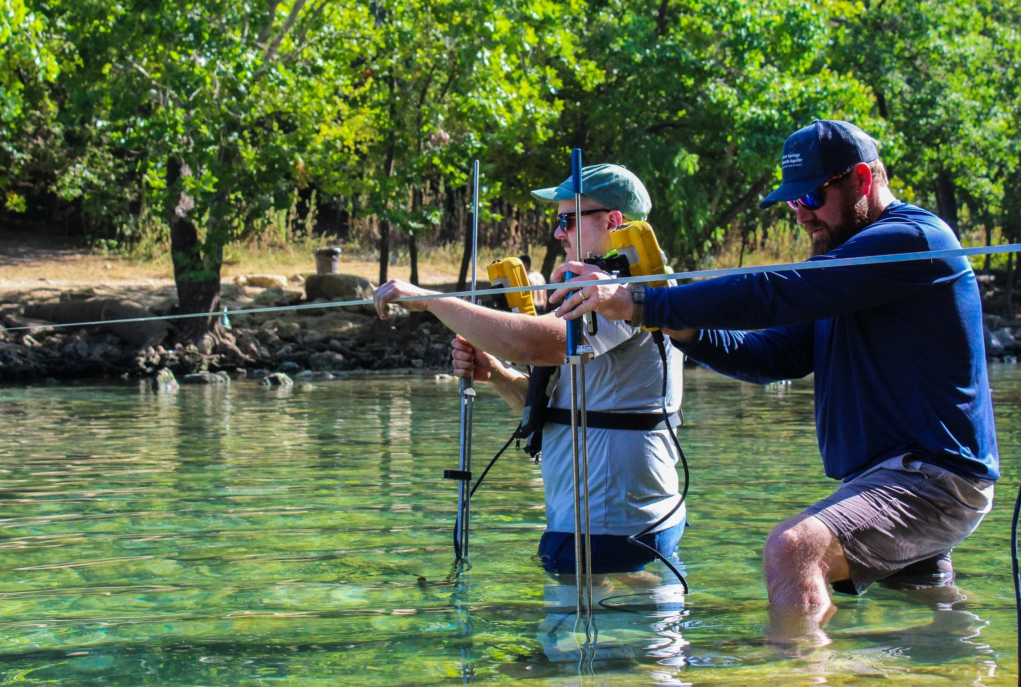 District and USGS staff collecting a Barton Springs springflow measurement | July 2023