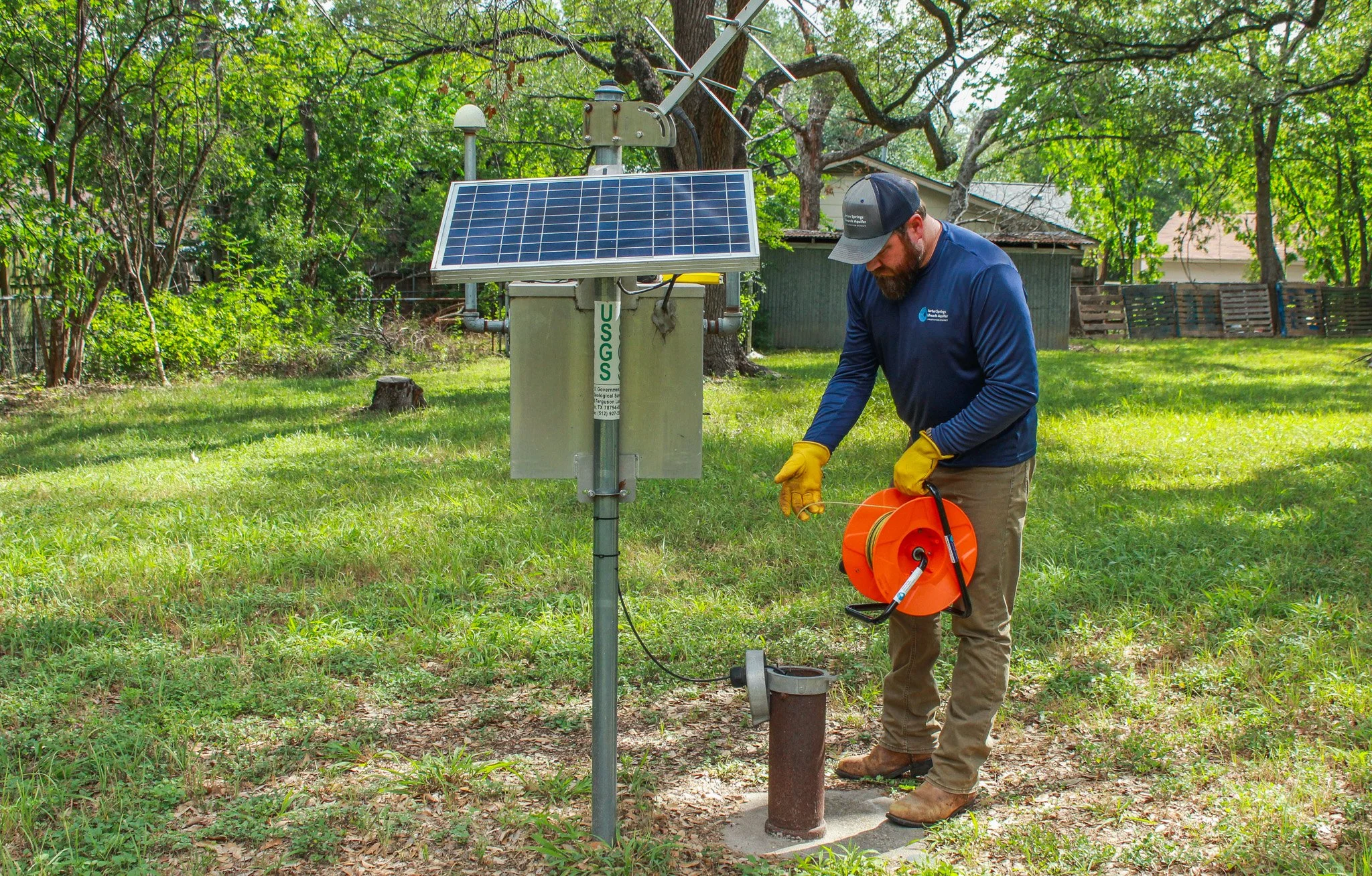 Justin Camp, Hydrogeologist Technician at the District, collecting a water level measurement at Lovelady monitor well | Photo by Shay Hlavaty, July 2025