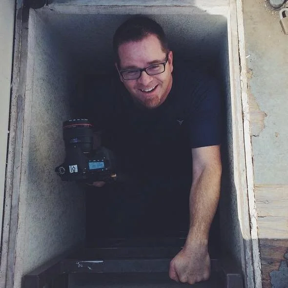 Climbing through a roof access to get the shot.