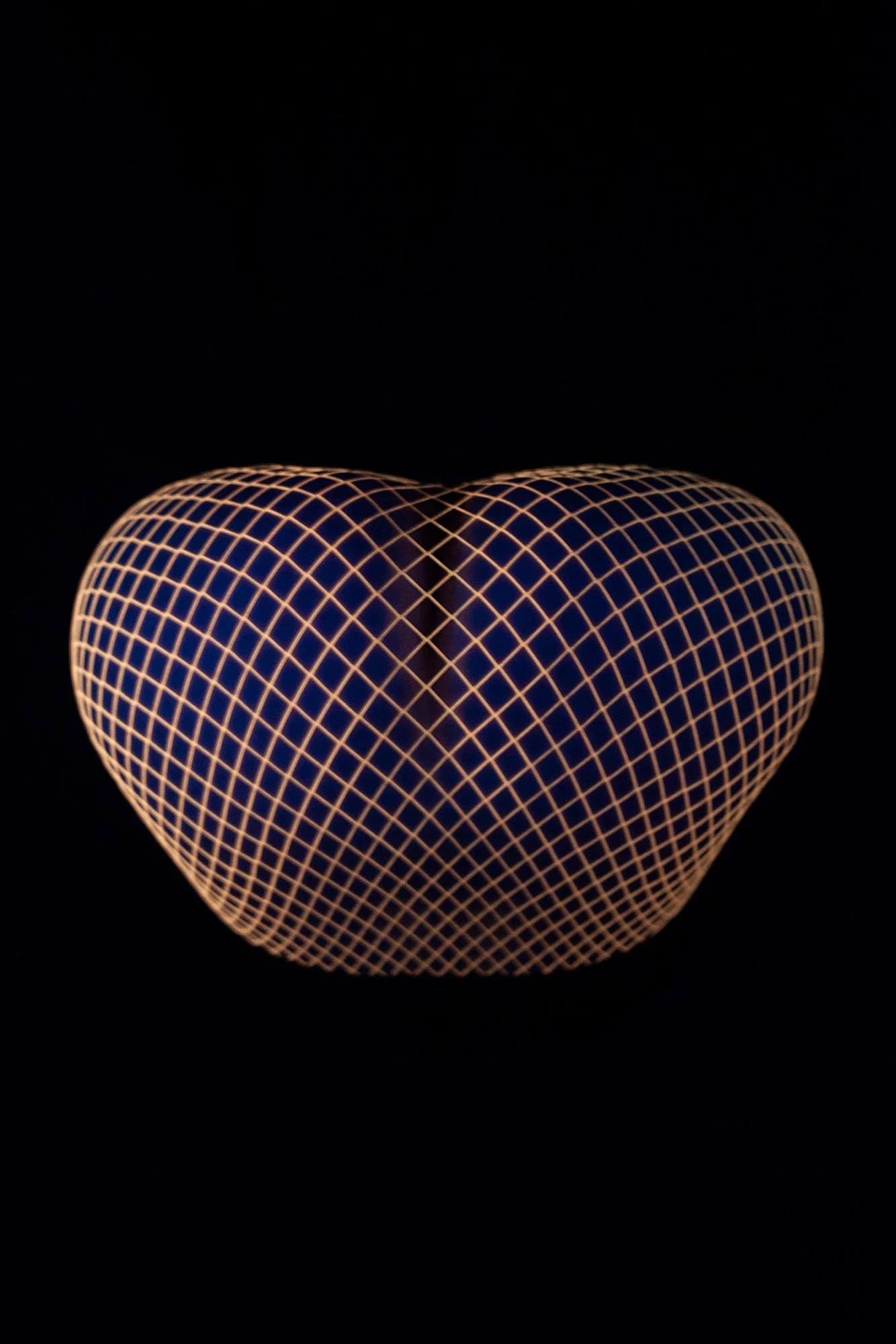 Close-up photograph of a female body wearing fishnet stockings forming abstract patterns from the conceptual photography series MISShapes by Beatriz Perez. 