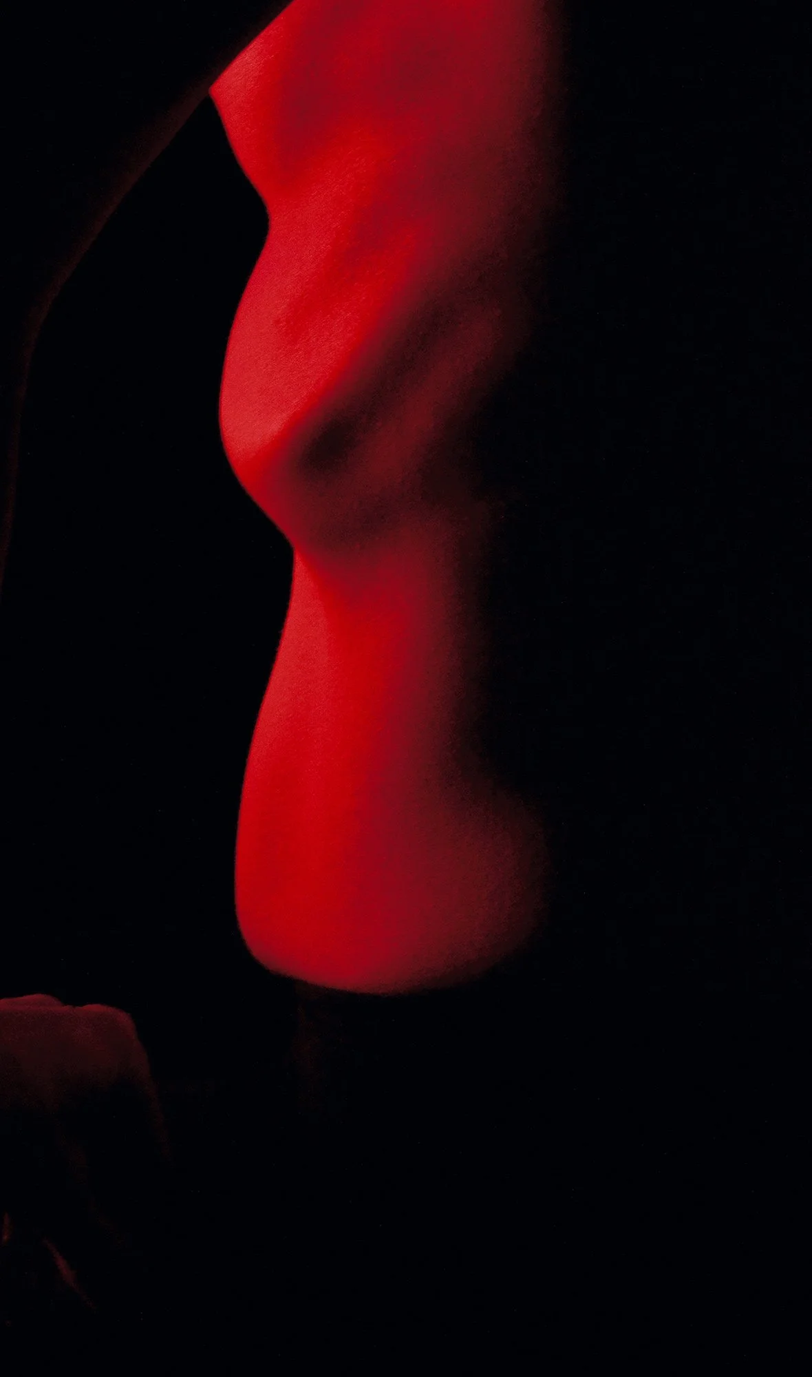Abstract photograph of a female ribcage forming geometric shadows through sculptural lighting from