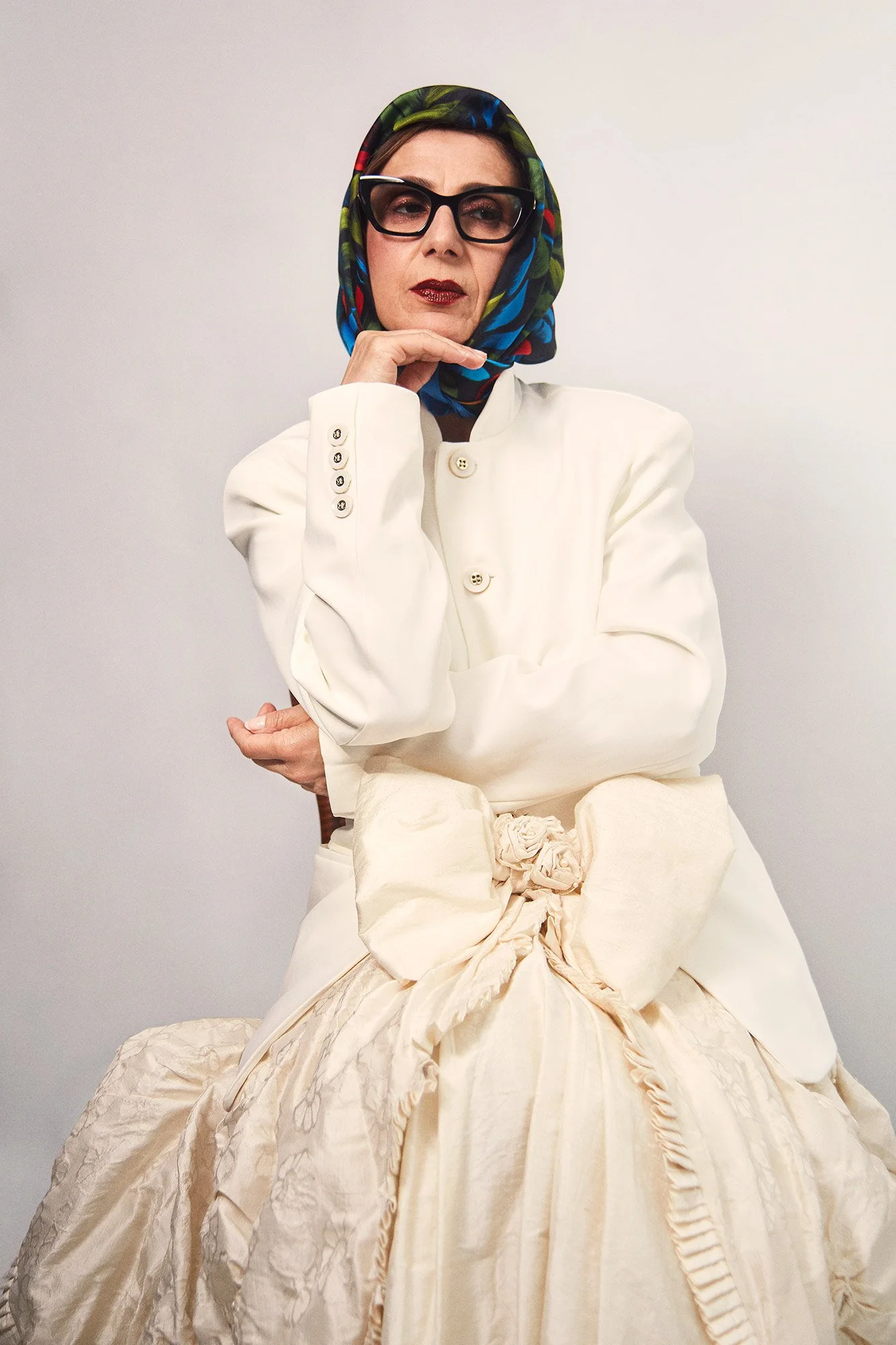 Photograph of La Abuela seated and wearing a traditional liqui-liqui in a reflective pose from the series Cuerpo Vestido, Alma Desnuda by Beatriz Perez.