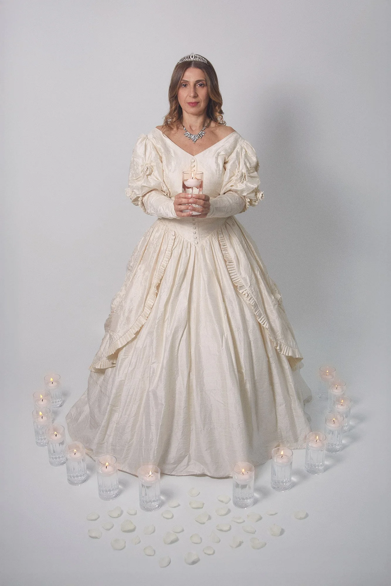 Photograph of La Quinceañera performing the candle ceremony, a coming-of-age tradition, from the series Cuerpo Vestido, Alma Desnuda by Beatriz Perez.