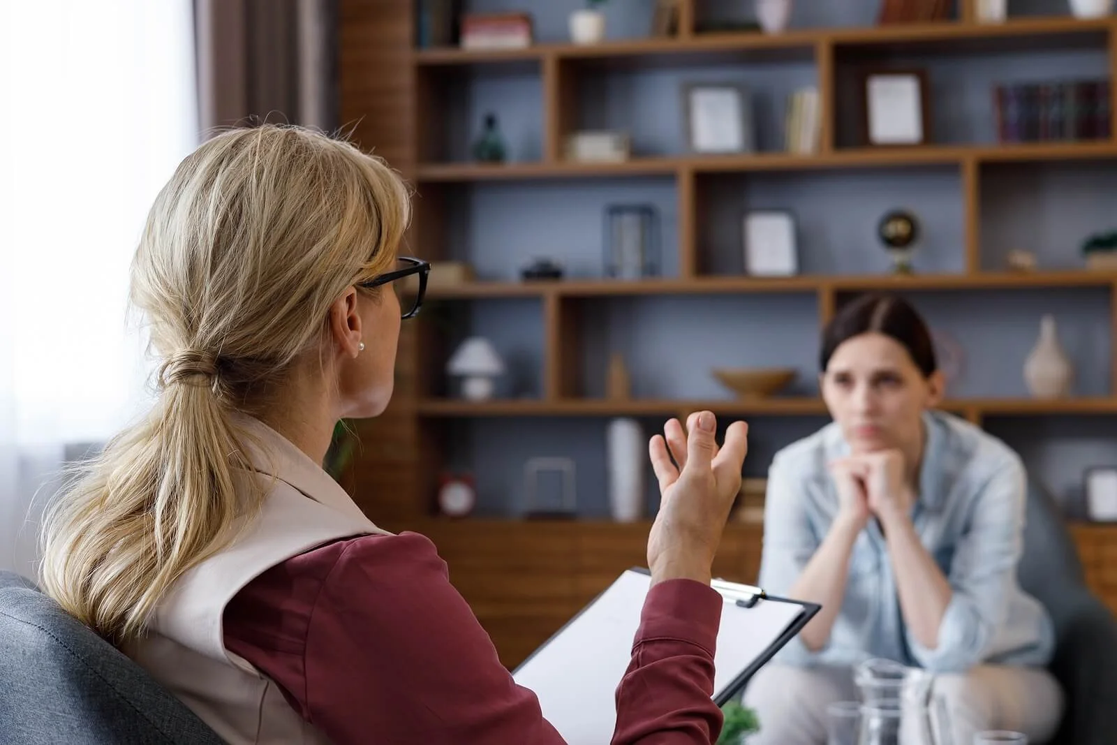 A client sits with hands clasped in session as a substance abuse counselor in St Paul, MN offers guidance. This kind of substance abuse counseling St Paul, MN provides often pairs with a trauma therapist in Saint Paul, MN.