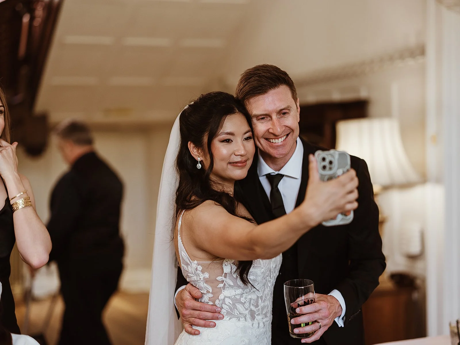 image of a bride and groom taking a selfie on their mobile phone