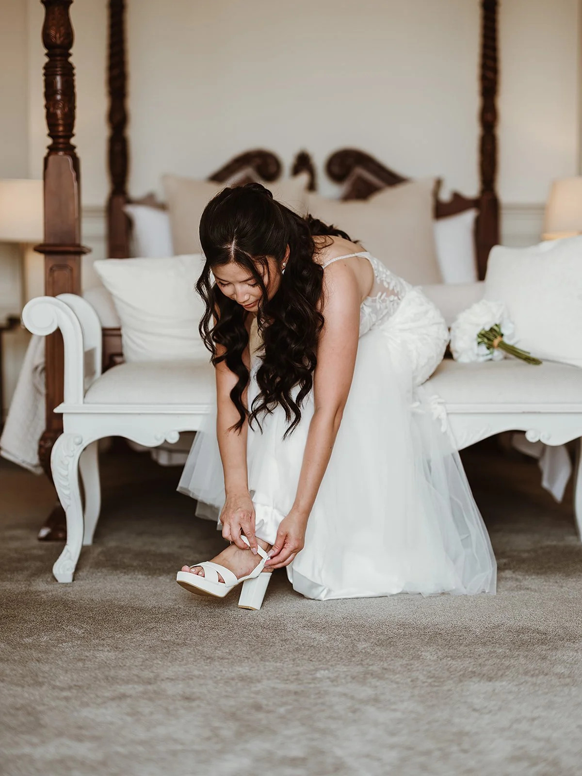 Bride putting on her wedding shoes at Highley Manor wedding venue