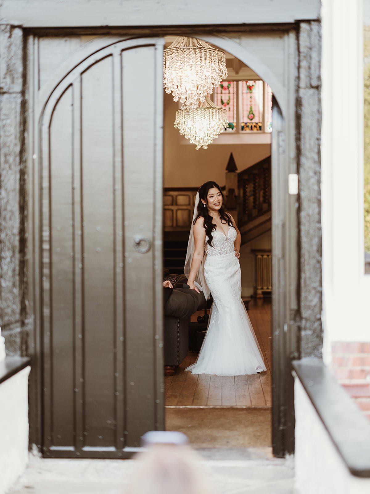 bride on her wedding day, standing in a doorway at Highley Manor wedding venue