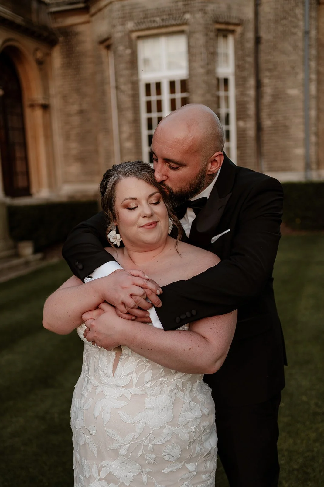 a bride and groom standing in front of Hedsor House wedding venue