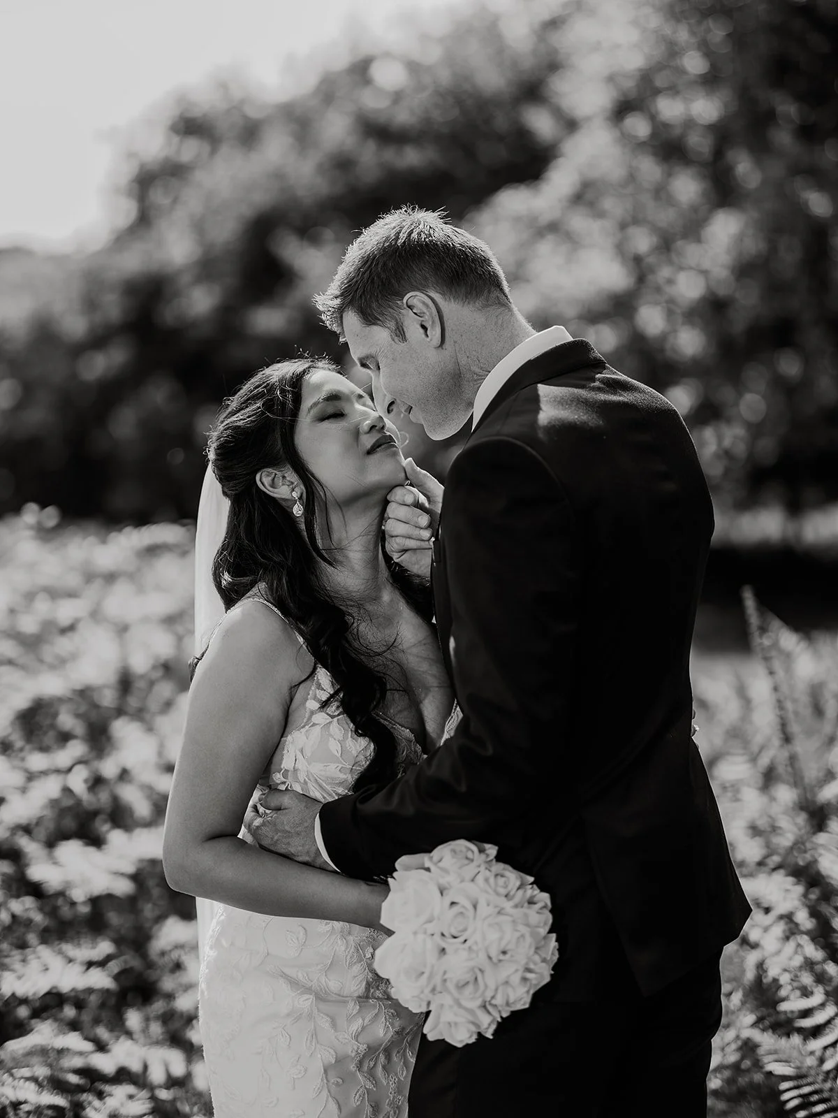 bride and groom on their wedding day sharing a kiss