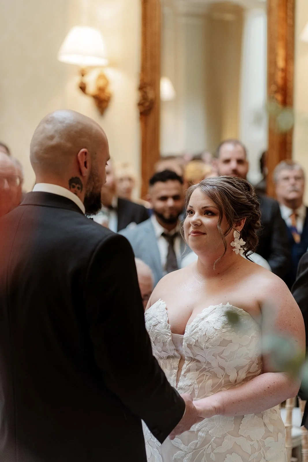 a bride and groom hold hands during their wedding ceremony at Hedsor House wedding venue