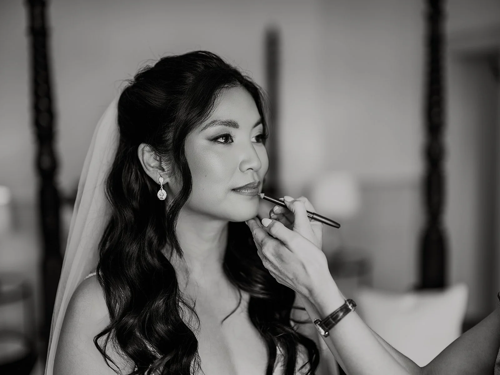 a bride having her final lipstick touches on her wedding morning