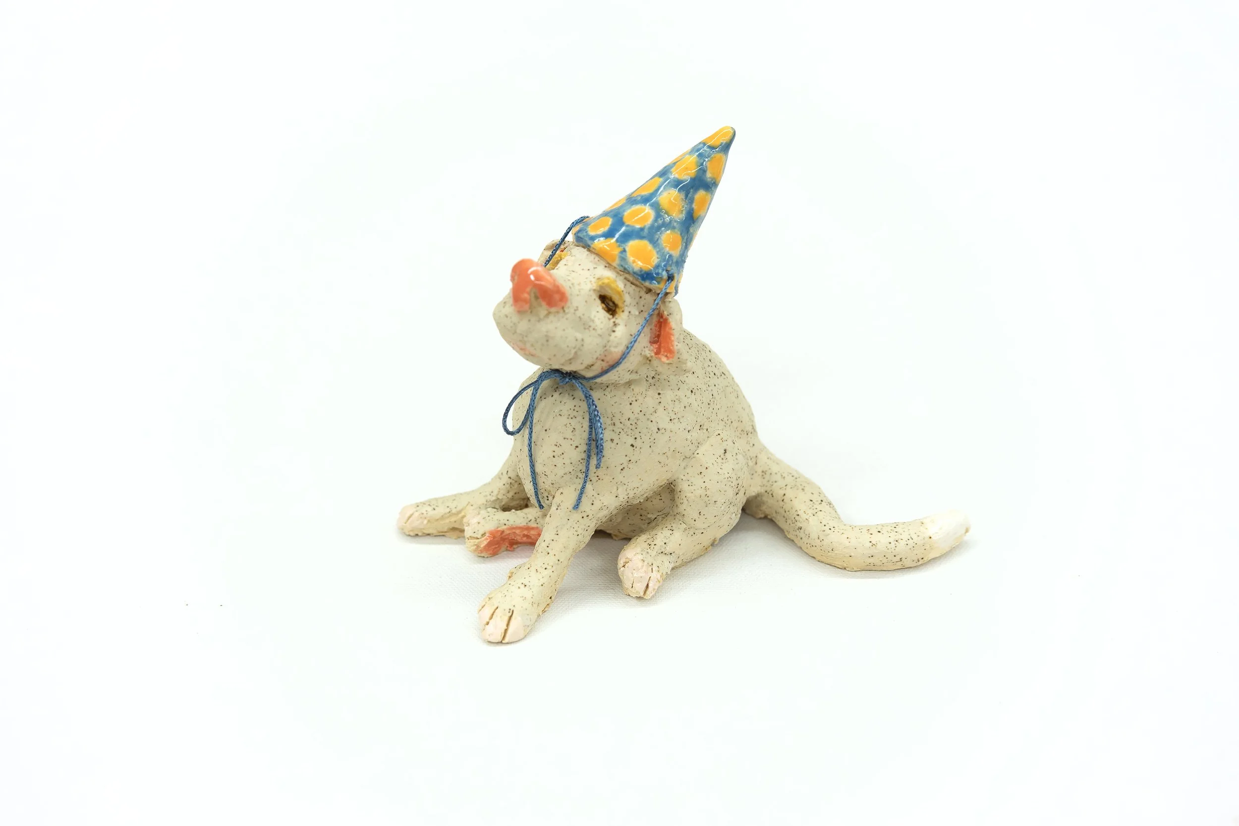 Party Animal | From the side |
4”H x 3"W x 5.5”D |
White Stoneware with Glaze and Silk Ribbon | 2026