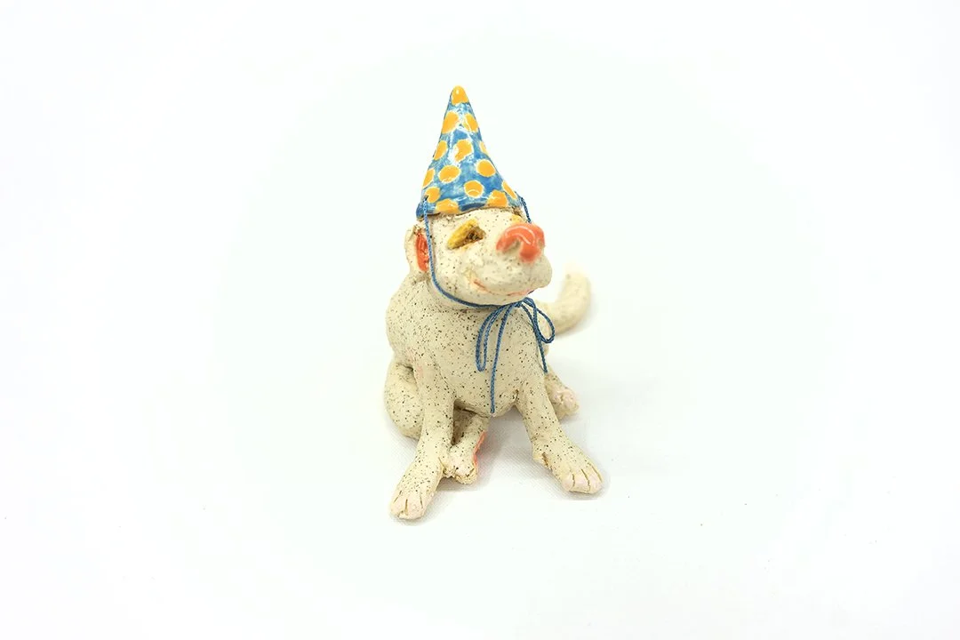 Party Animal | Head on |
4”H x 3"W x 5.5”D |
White Stoneware with Glaze and Silk Ribbon | 2026
