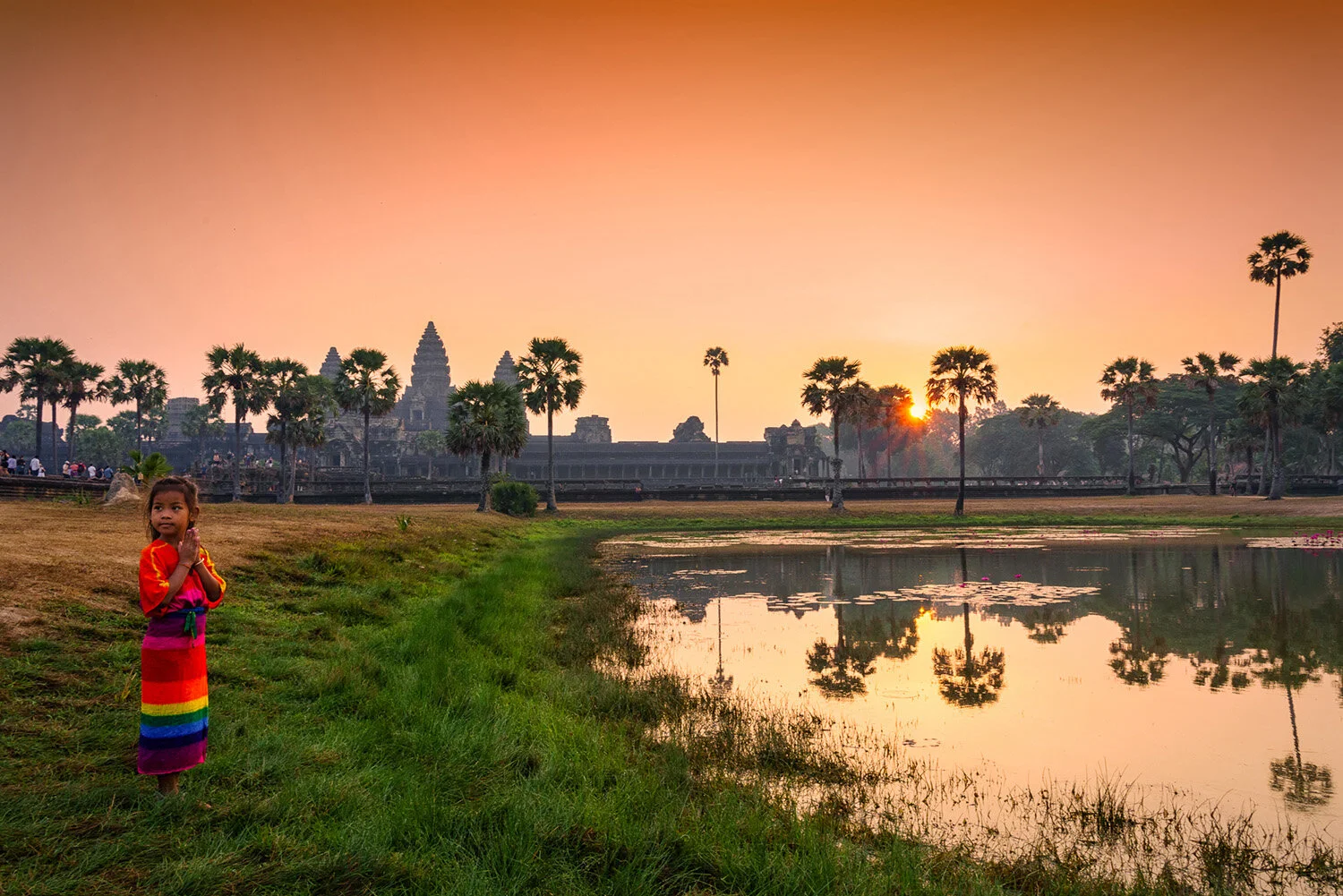  Cambodian girl at sunrise in Angkor Wat, Cambodia. 