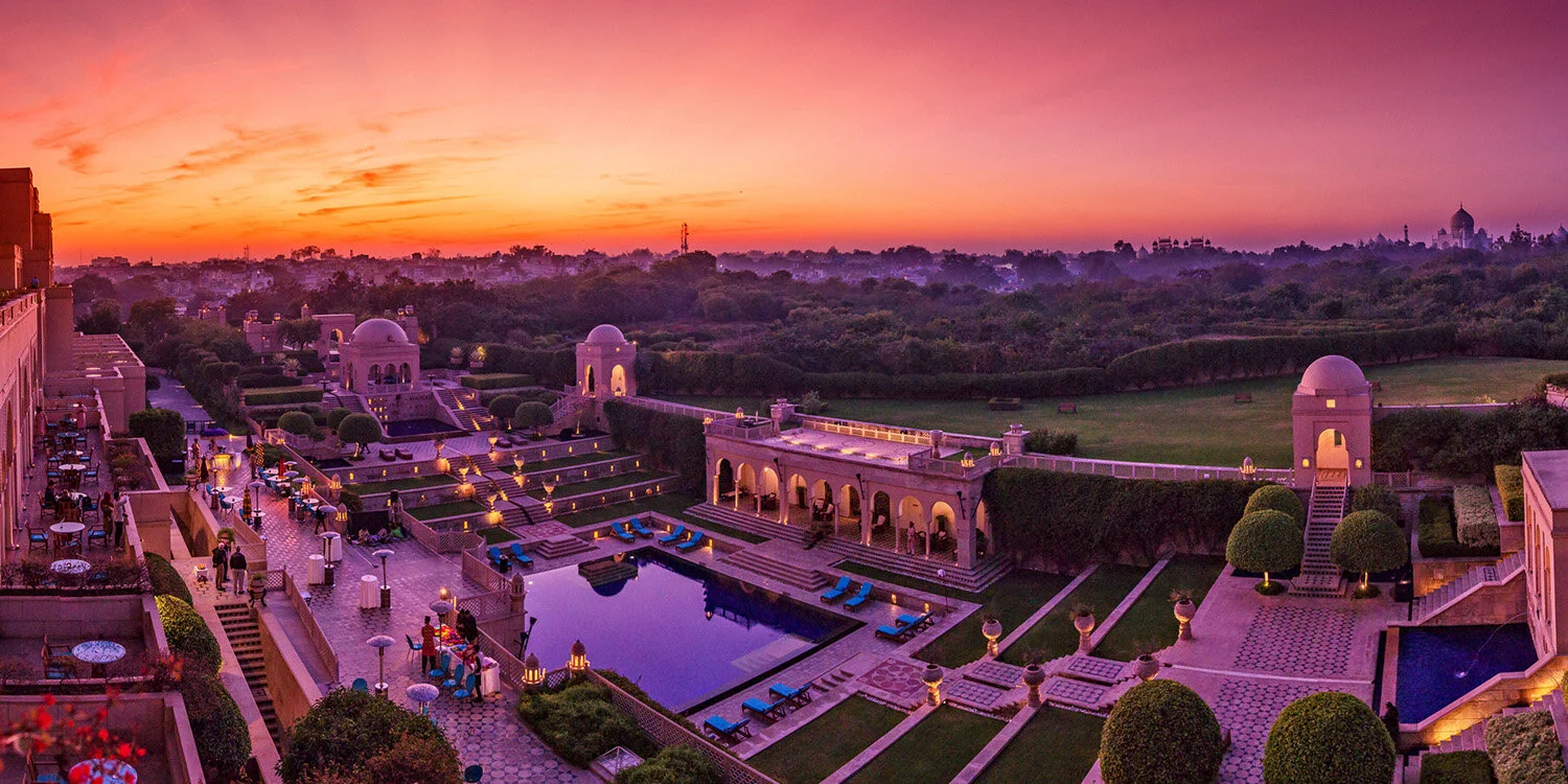  Sunset panorama at The Oberois Amarvillas luxury hotel with pool overlooking Taj Mahal in Agra, India. 