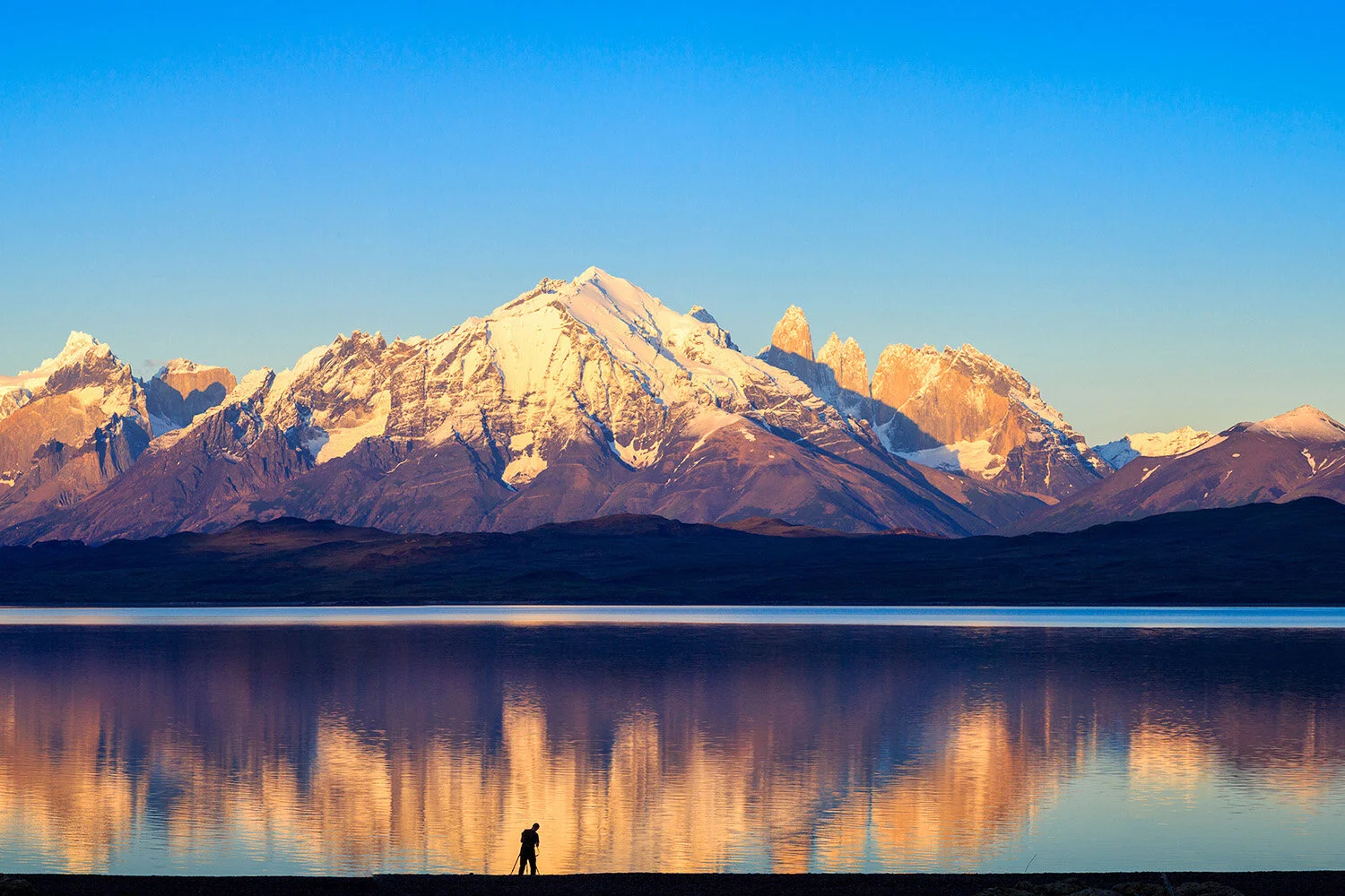  Photographer at Lake Sarimento in Torres del Paine NP in Patagonian Chile photographs icon towers. 