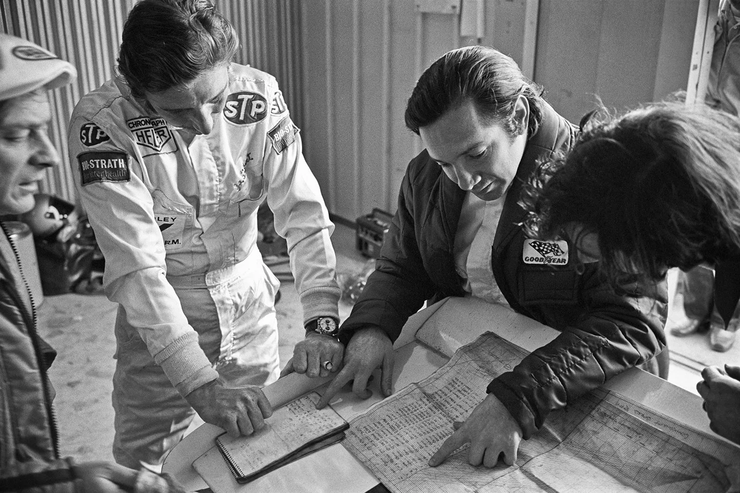 Brabham drivers Jo Siffert and Pedro Rodriquez check gearing charts in search of 300 RPM more at Questor GP in 1971. Siffert died in an October crash, Rodriquez in July.