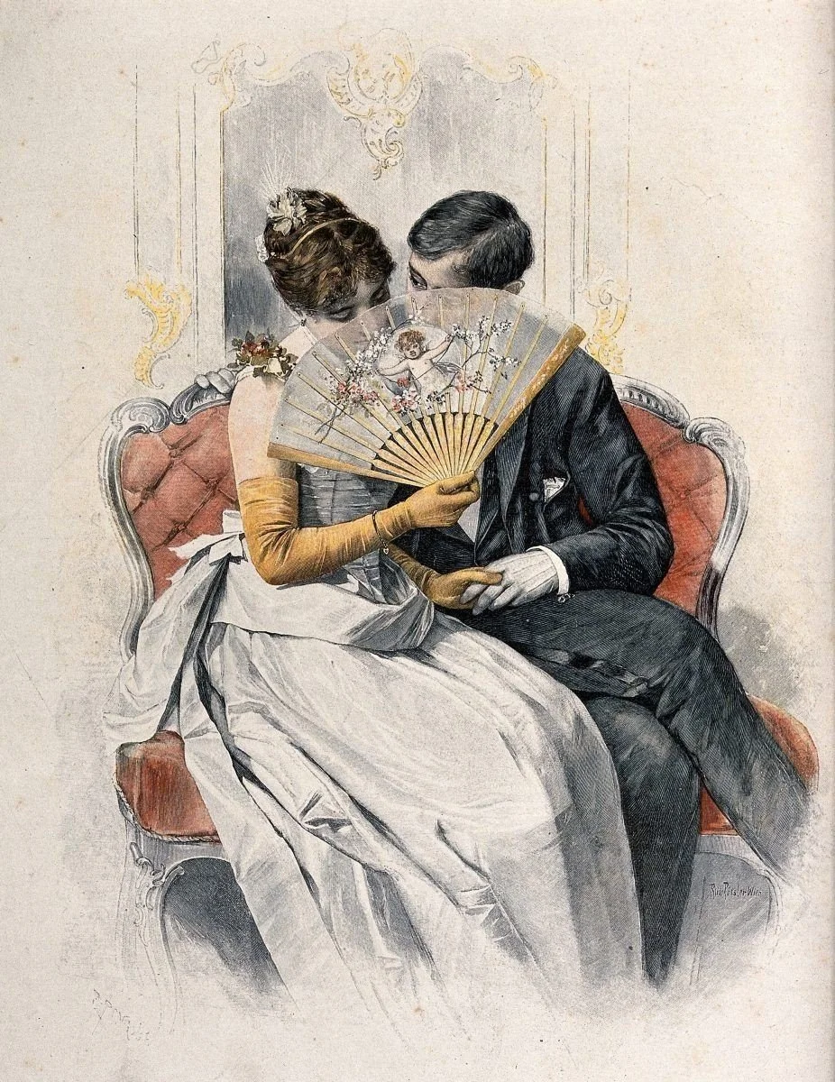 It depicts a young couple sitting on a sofa, with the woman using a fan to hide her face as they kiss.