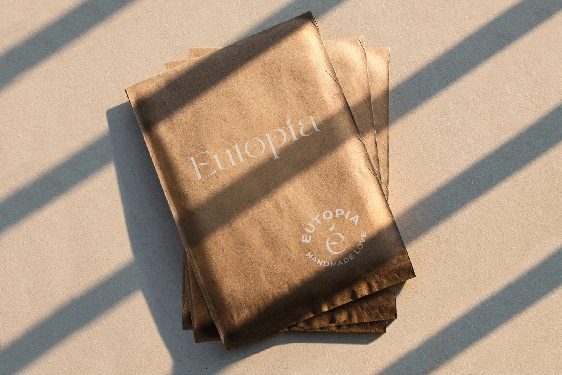 Branding mockups for Eutopía, highlighting Branding Kit and 1:1 Mentoring applied to handcrafted products for peaceful home living