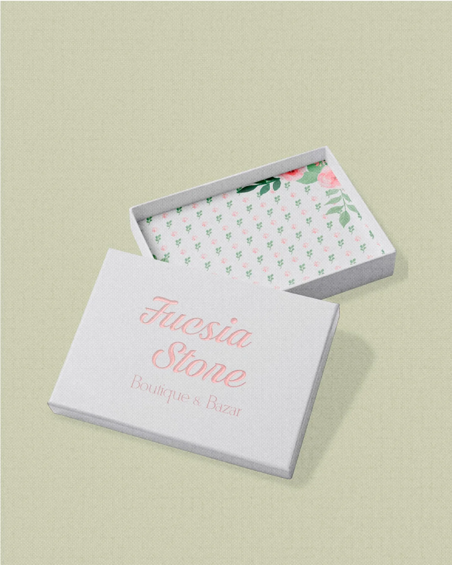 White box with open lid showing "Fuchsia Store Boutique & Press" in pink script, floral interior pattern