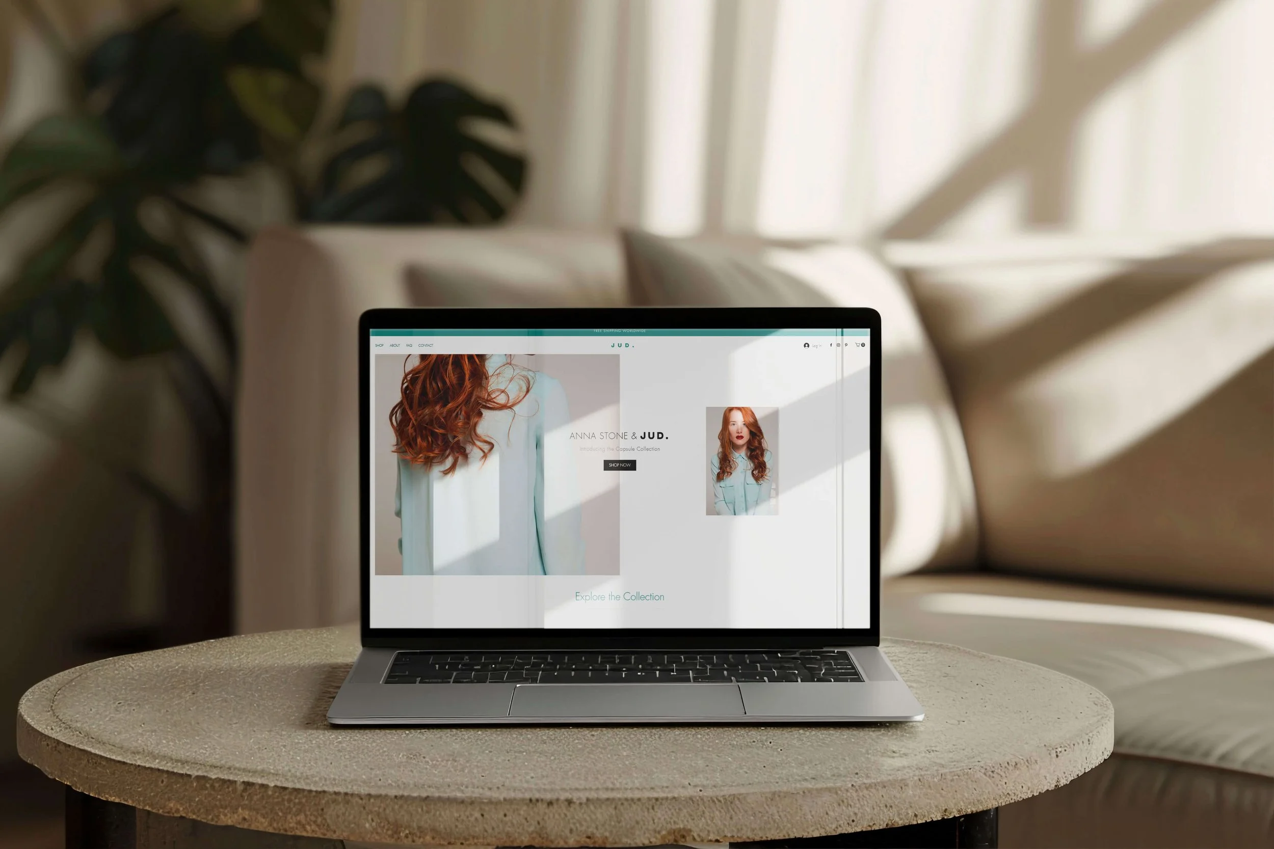 Laptop on a marble table, showcasing the online shop interface.