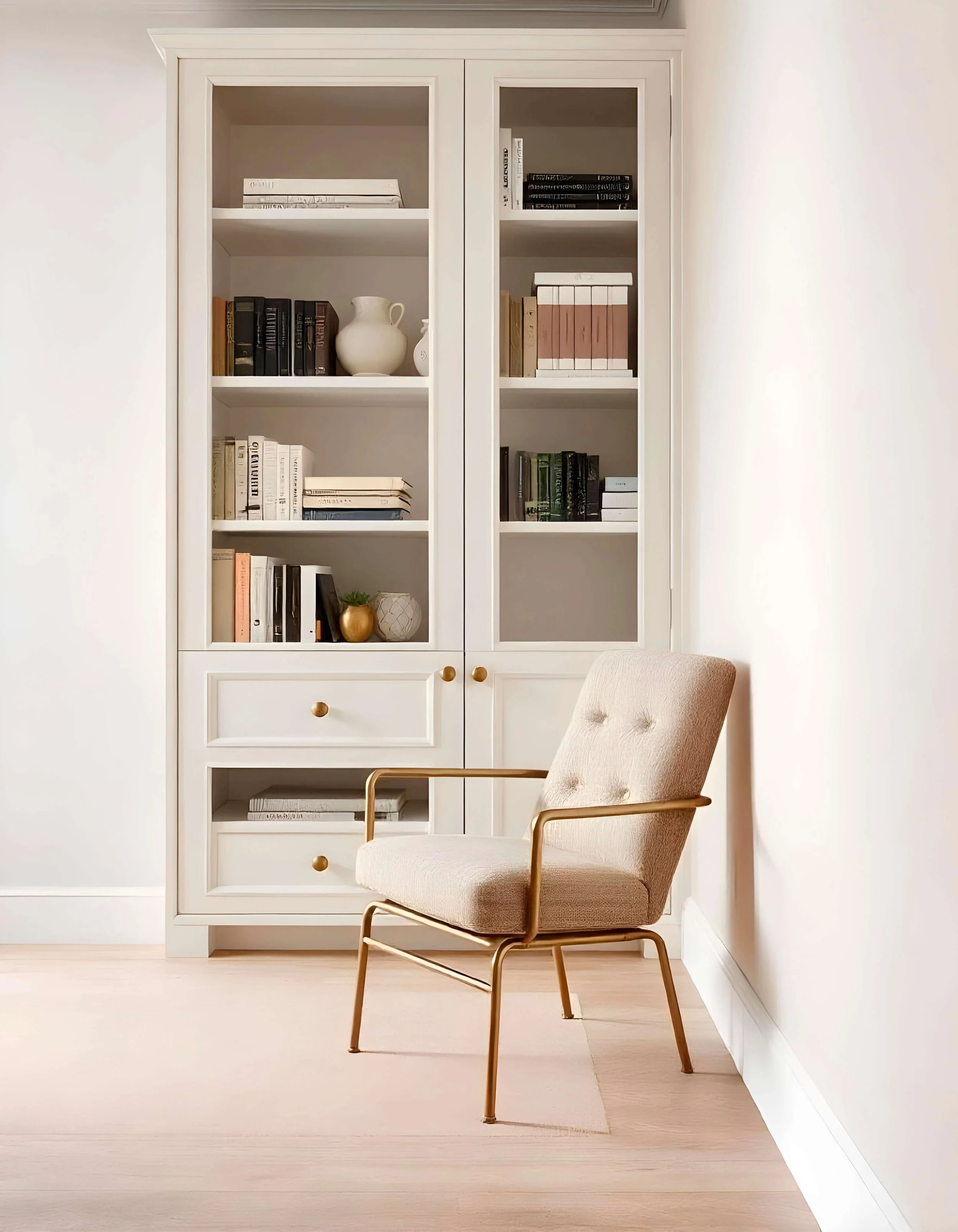 A minimalist and sophisticated office corner featuring a white bespoke bookshelf and a premium armchair, representing the strategic clarity and high-end design of Networking Digital Creative House.