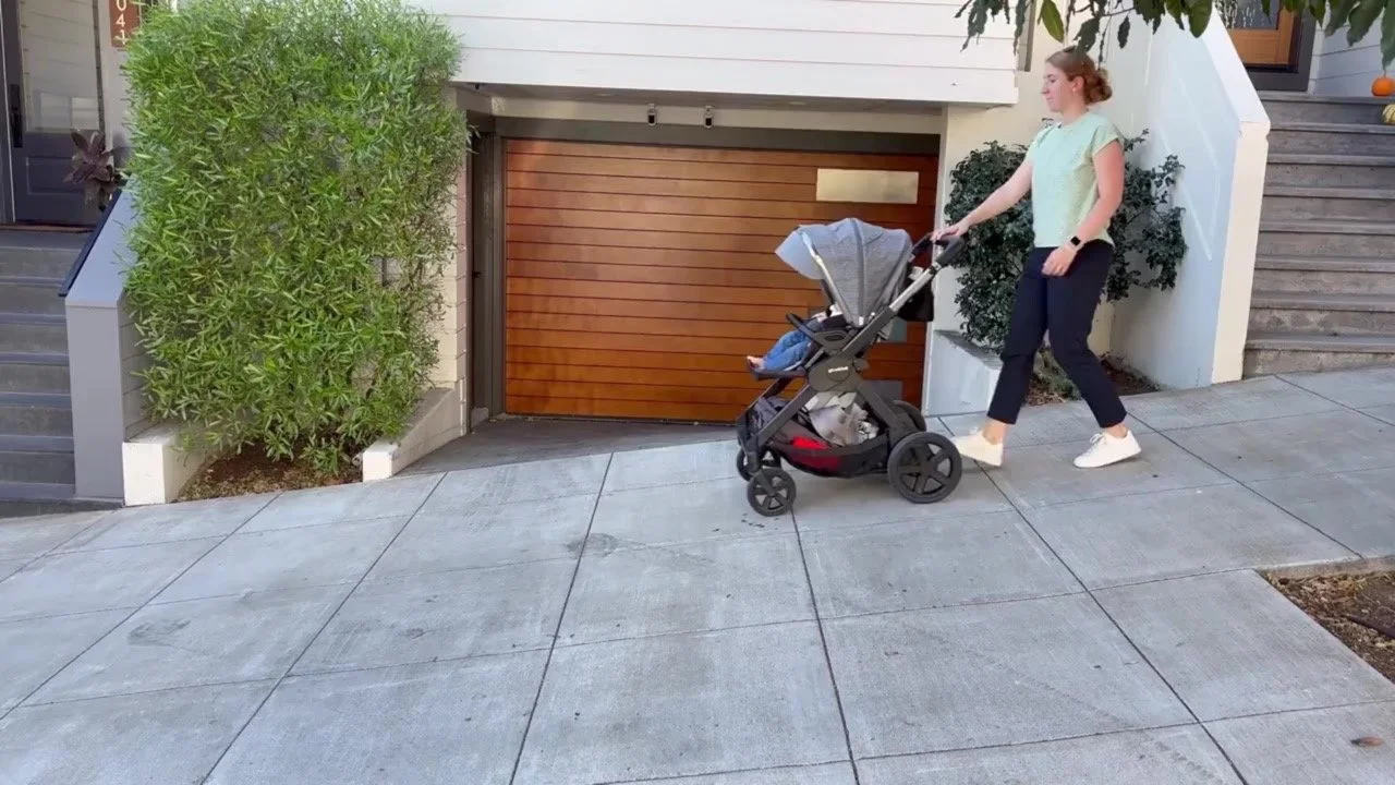 Woman walking downhill and letting go of stroller Large.jpeg