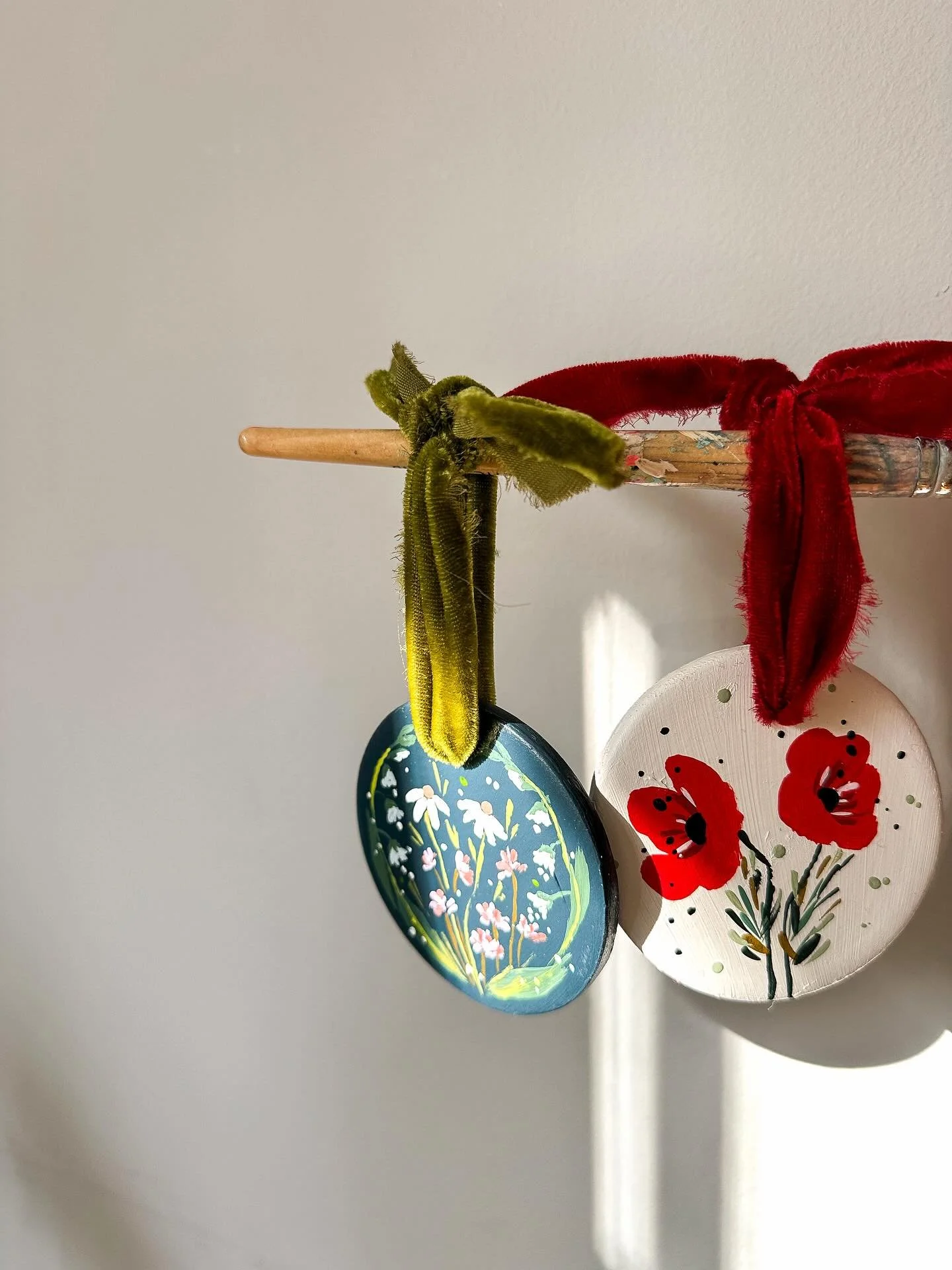 Two hand painted ornament designs this year! Both ceramic with velvet ribbon to hang on the tree or your wall. 

The red poppy design has a sparkling back to catch the winter light while the blue wildflower design is matte. 

#handpaintedornaments
