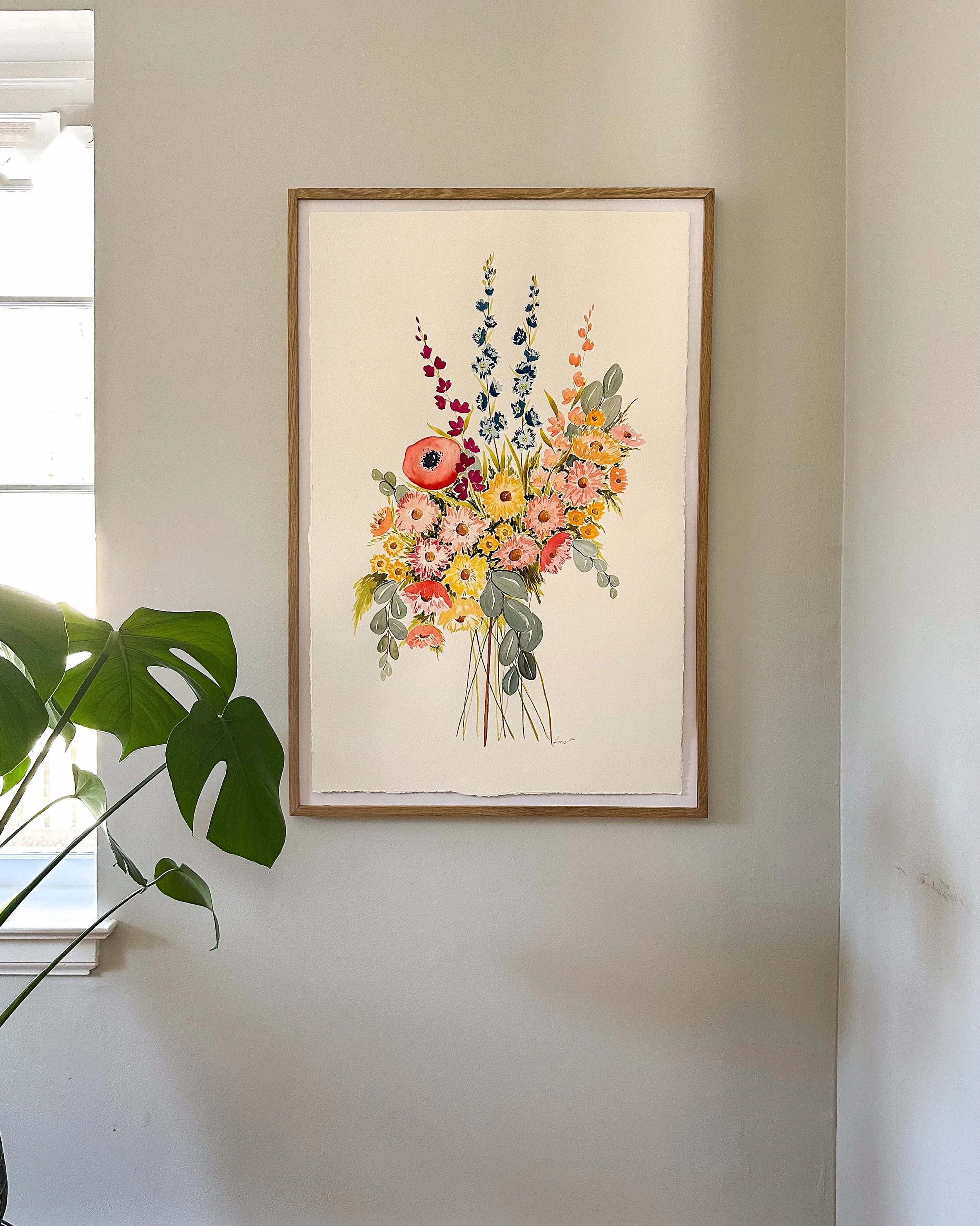 the diamond framed on wall with greenery.jpeg