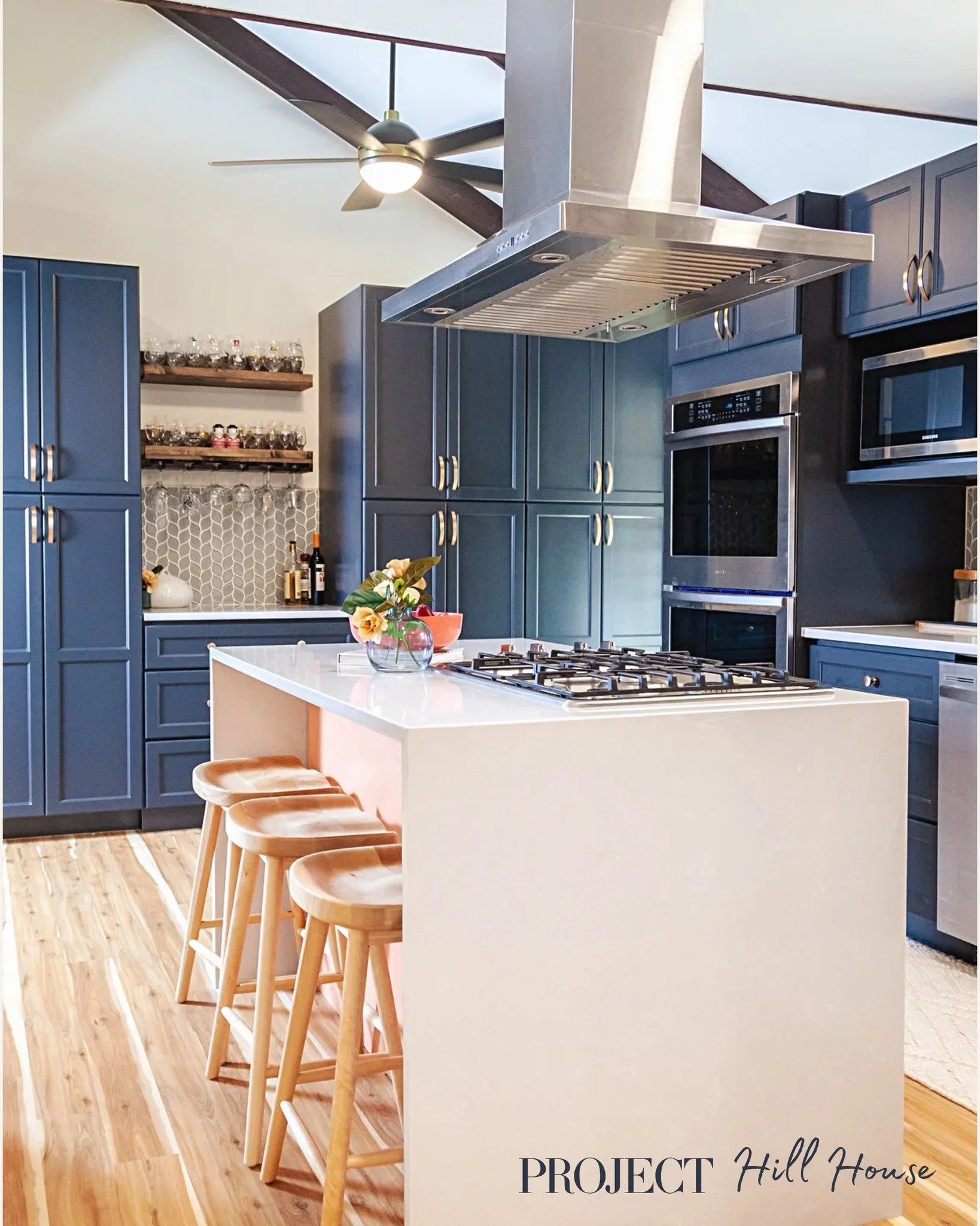 Navy and coral isn't a combination you see every day &mdash; and that's exactly why it works. This kitchen was a full gut renovation, down to removing a wall to open the entire floorplan. The result is a space that's bold without being loud, and func