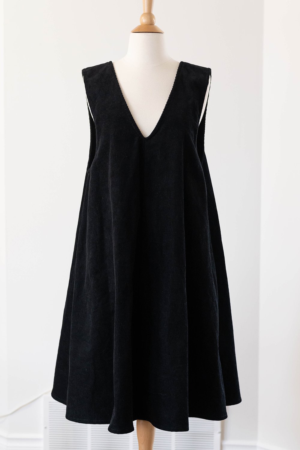 A pinafore with black corduroy fabric