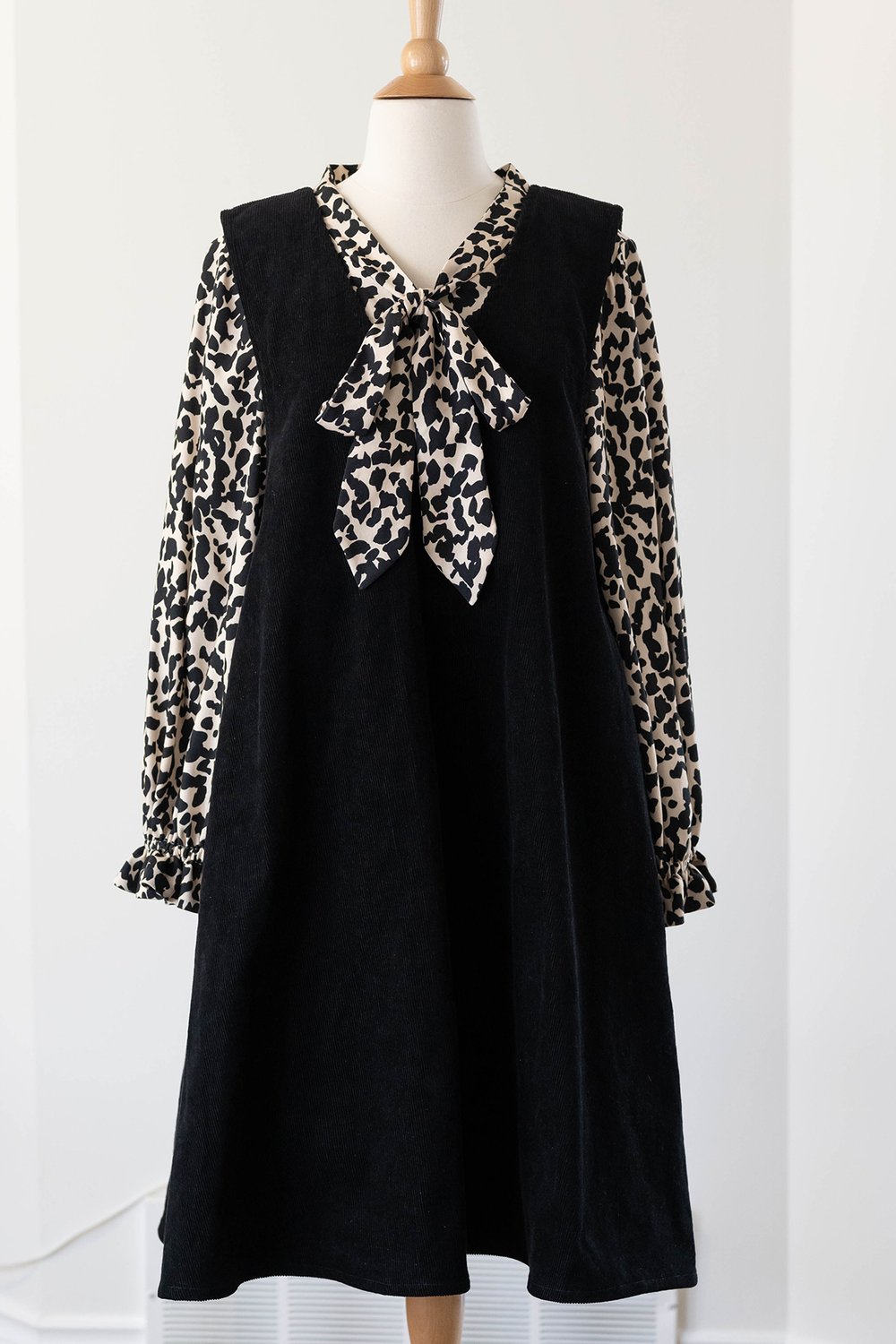 Black corduroy pinafore with a leopard print top