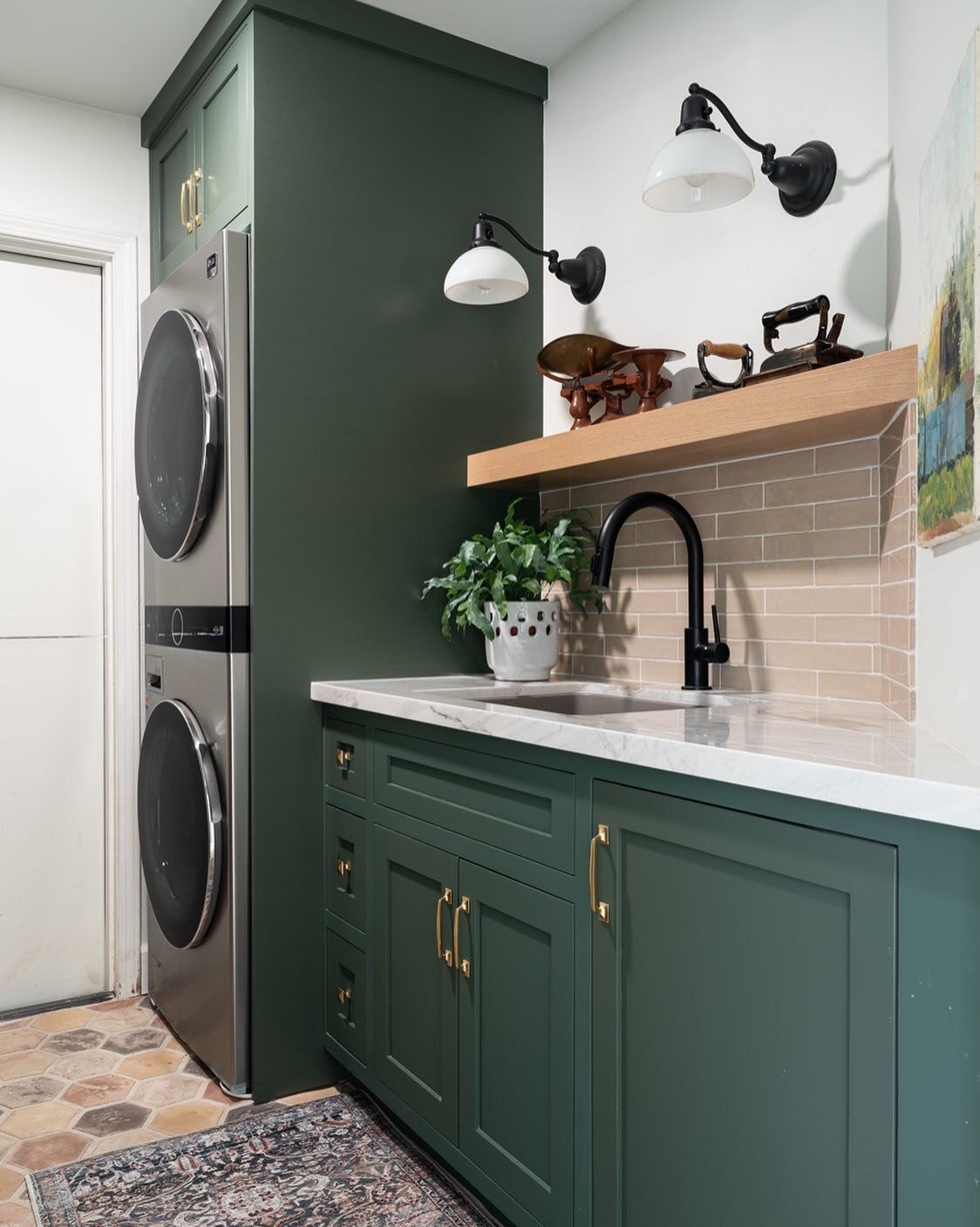 Green Cabinets in a Laundry Room Remodel check all the boxes! Soothing but fresh color in a workspace is so important. Make sense changes included relocating a heater to expand the area allowing more cabinets for storage and new drop zone. Check out 