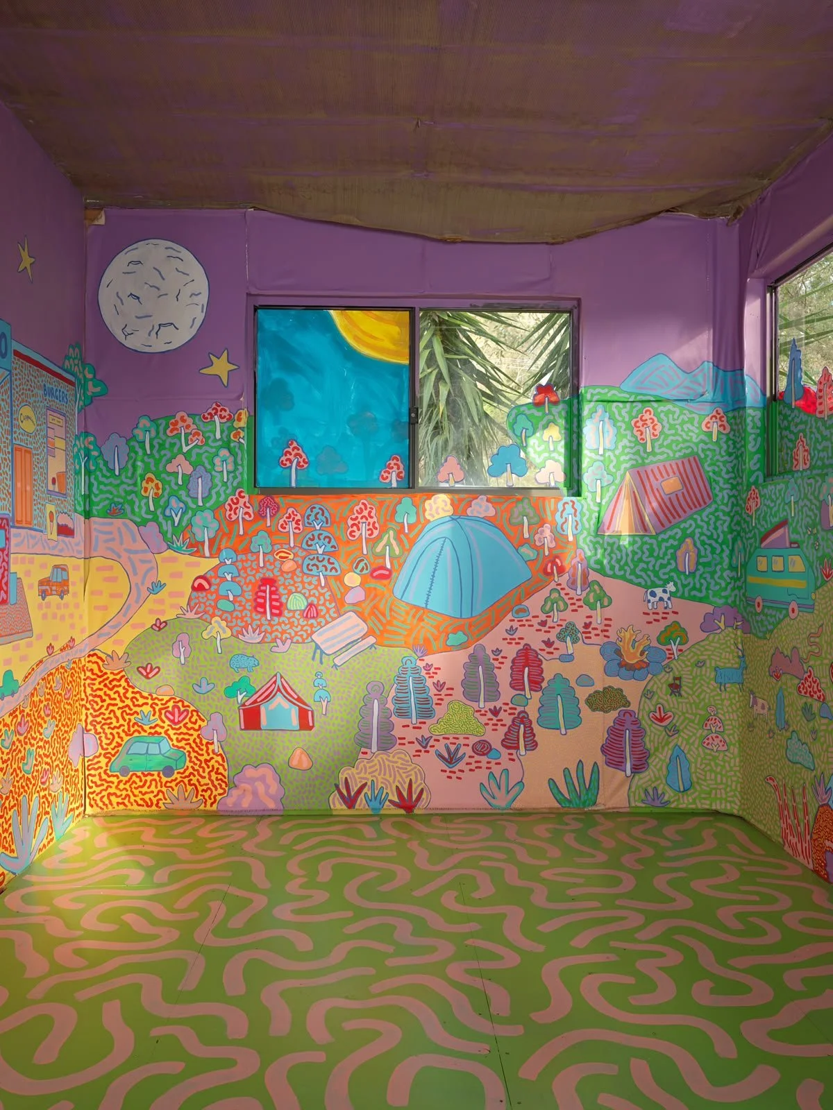 Whimsical mural featuring a moonlit landscape, colourful hills, native plants and playful illustrations, part of Kat Tillman's Side Quest Stories art project.
