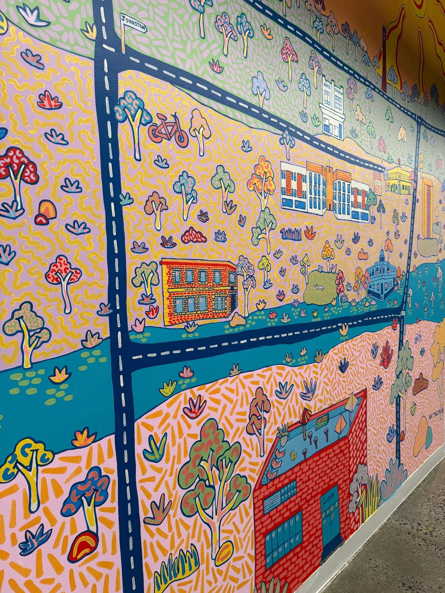 Close-up of a colourful illustrated Collingwood streetscape mural by Melbourne mural artist Kat Tillman.
