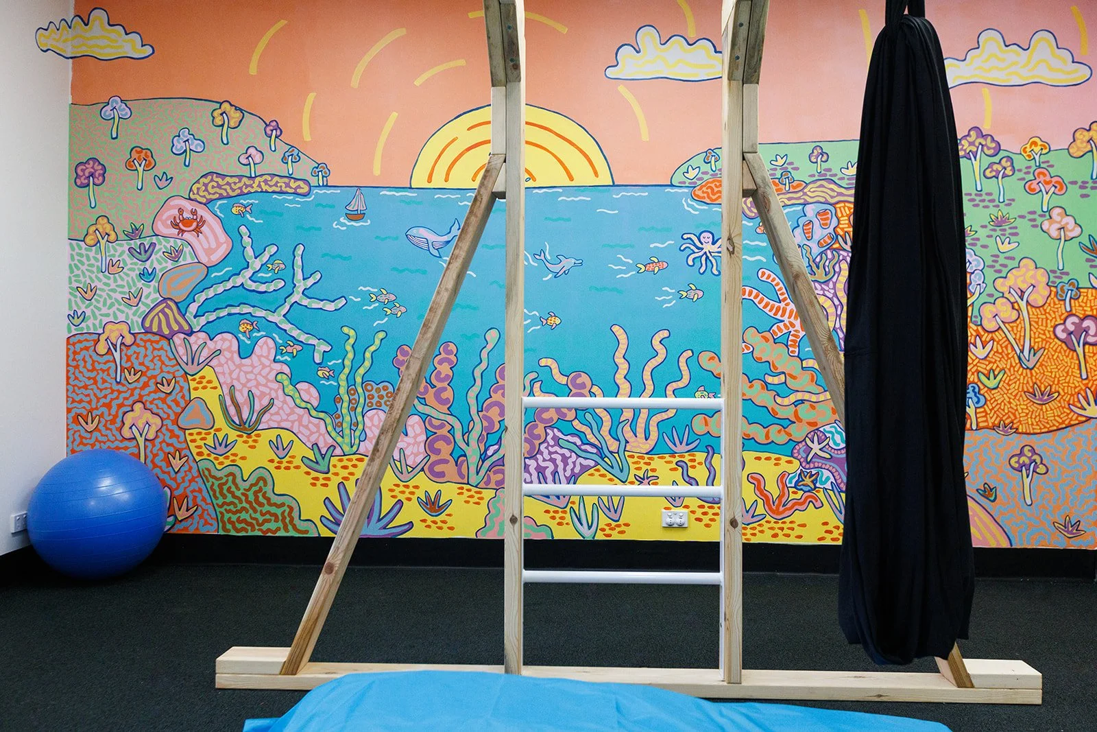 Colourful underwater mural by Melbourne artist Kat Tillman in a children’s therapy room at Latrobe Community Health Service in Churchill, Victoria.