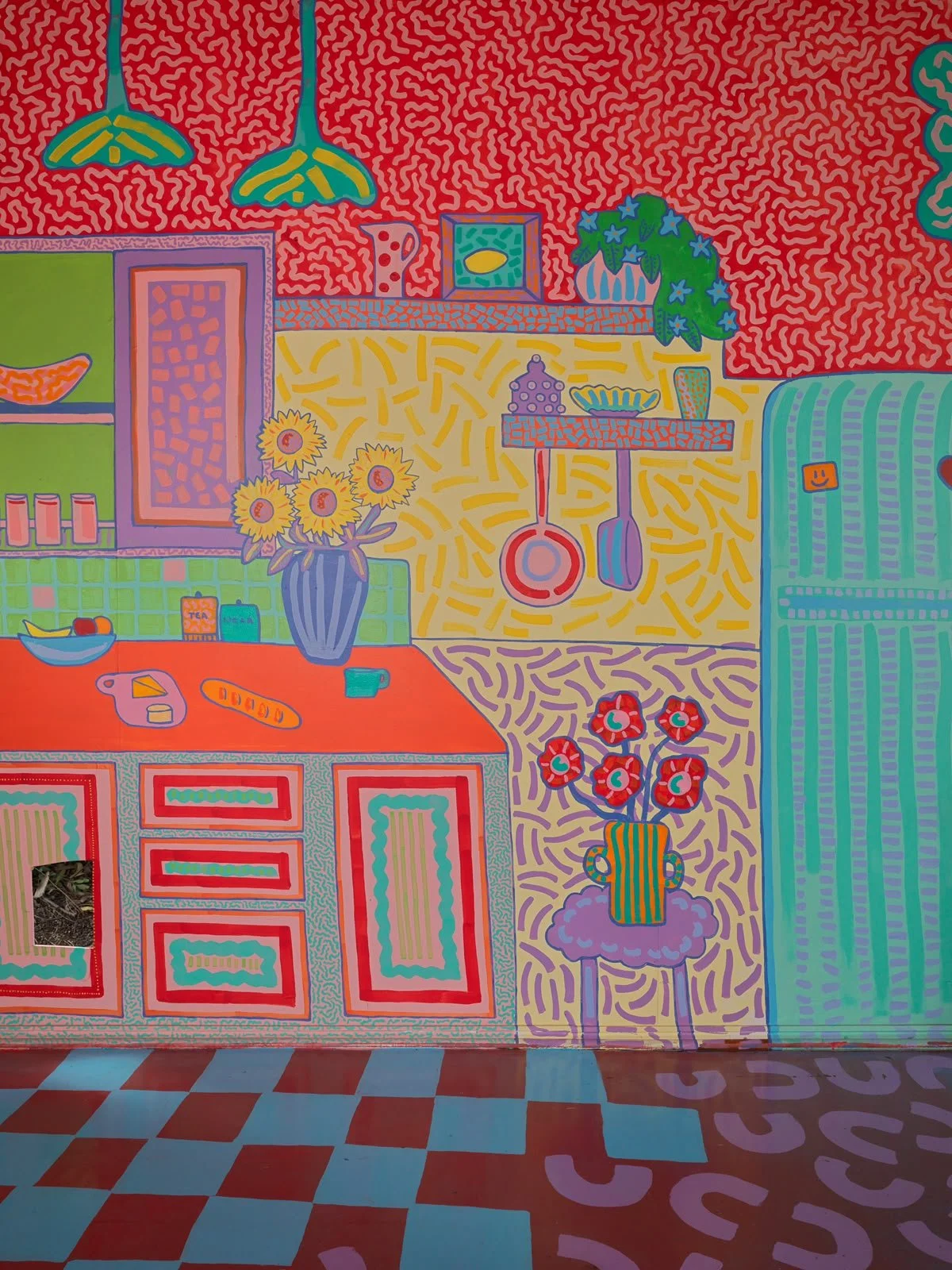 Detailed interior mural featuring illustrated furniture, flowers, household objects and colourful architectural elements, painted by Melbourne artist Kat Tillman.