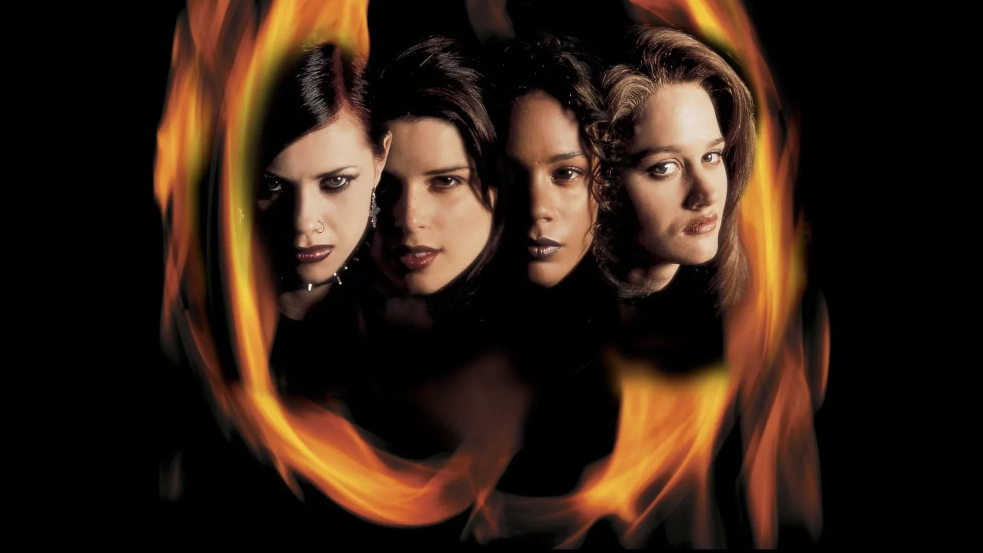 Promotional artwork for The Craft (1996) featuring Fairuza Balk, Robin Tunney, Rachel True and Neve Campbell framed by a swirling ring of flames against a black background.