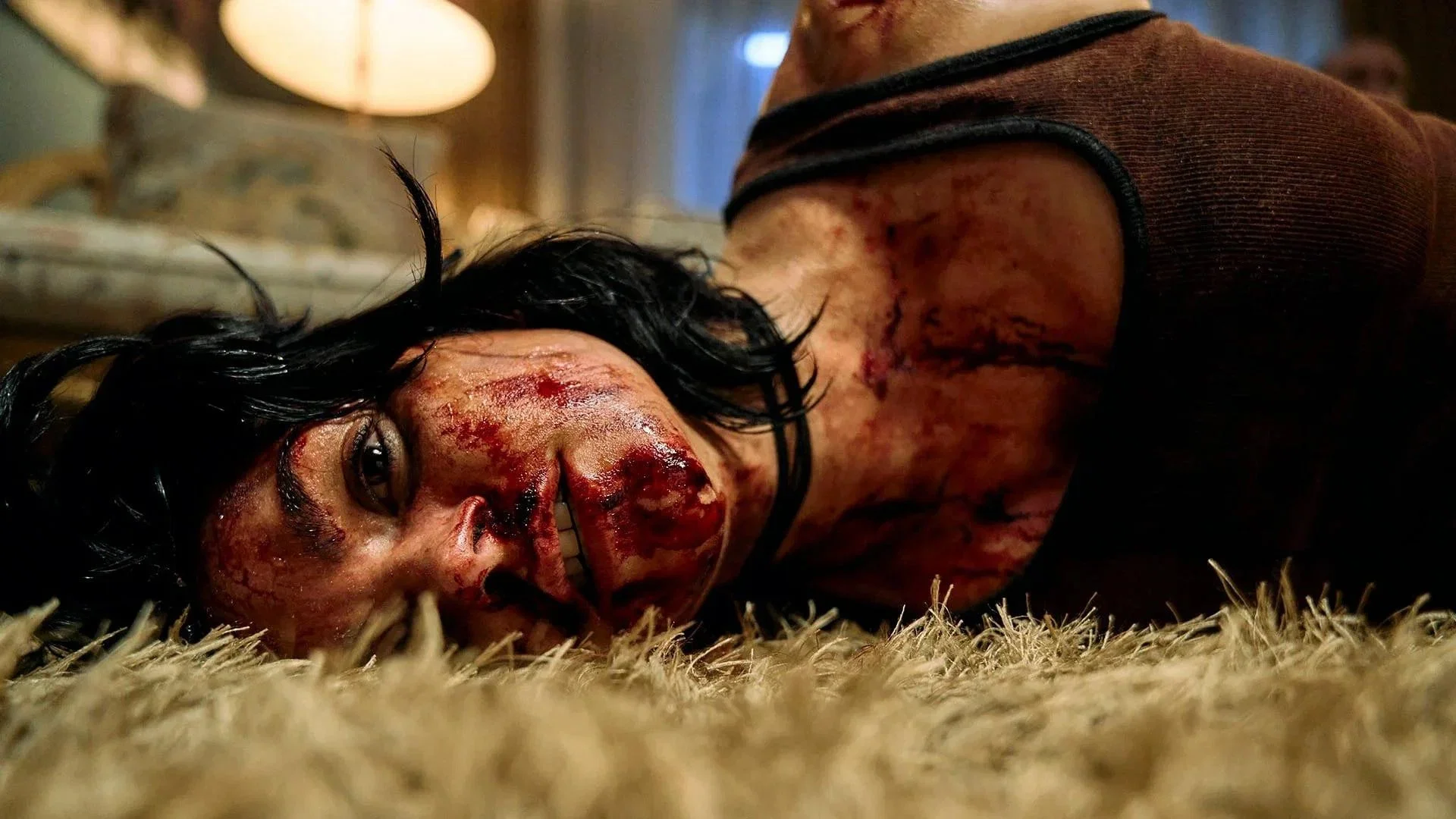 A bloodied character lies injured on the floor in Penny Lane Is Dead (2026).
