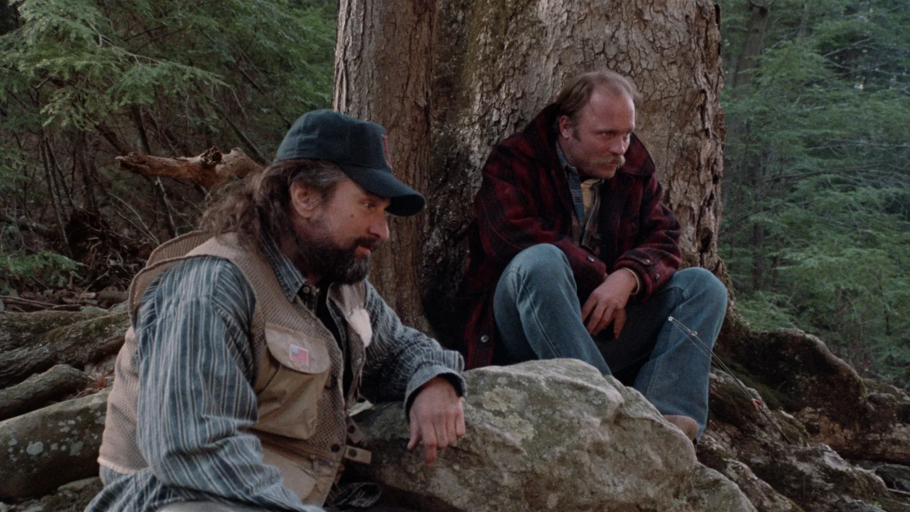 Robert De Niro and Ed Harris sit together in the woods as Vietnam veterans Megs and Dave in Jacknife (1989).