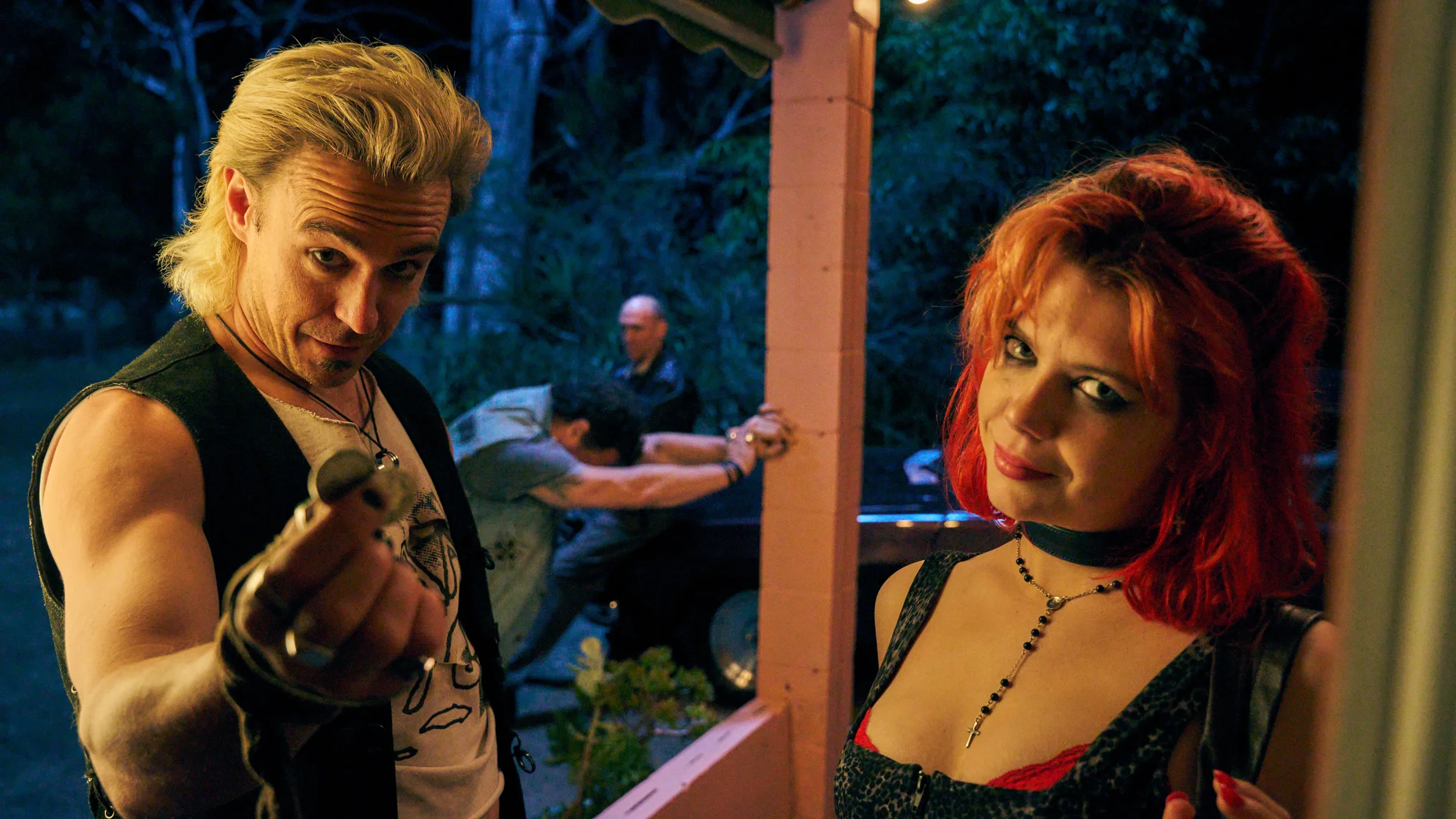 Two threatening figures stand outside a house at night in Penny Lane Is Dead (2026).