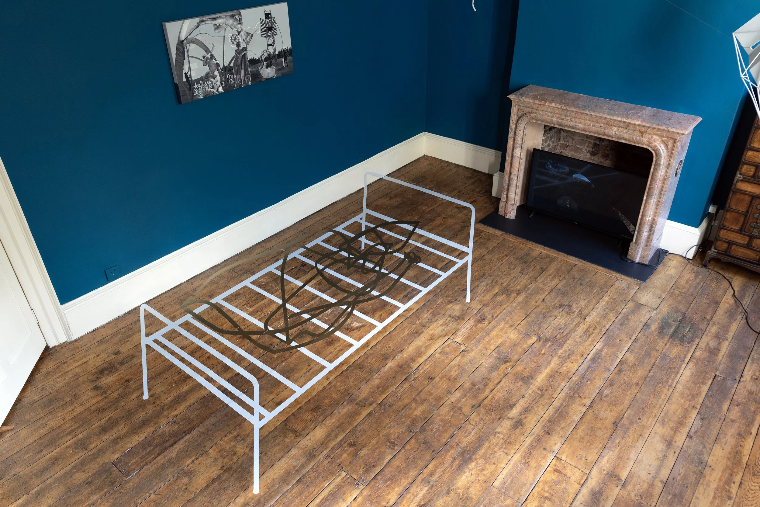 Propellers and Propositions (2024)
Vinyl, closed-circuit video camera, HD monitor. Floor section: H 330 x 183 cm, wall section: H 15 x 32 cm. Installation view Danielle Arnaud Gallery, London, 2024. © Ergin Çavuşoğlu.