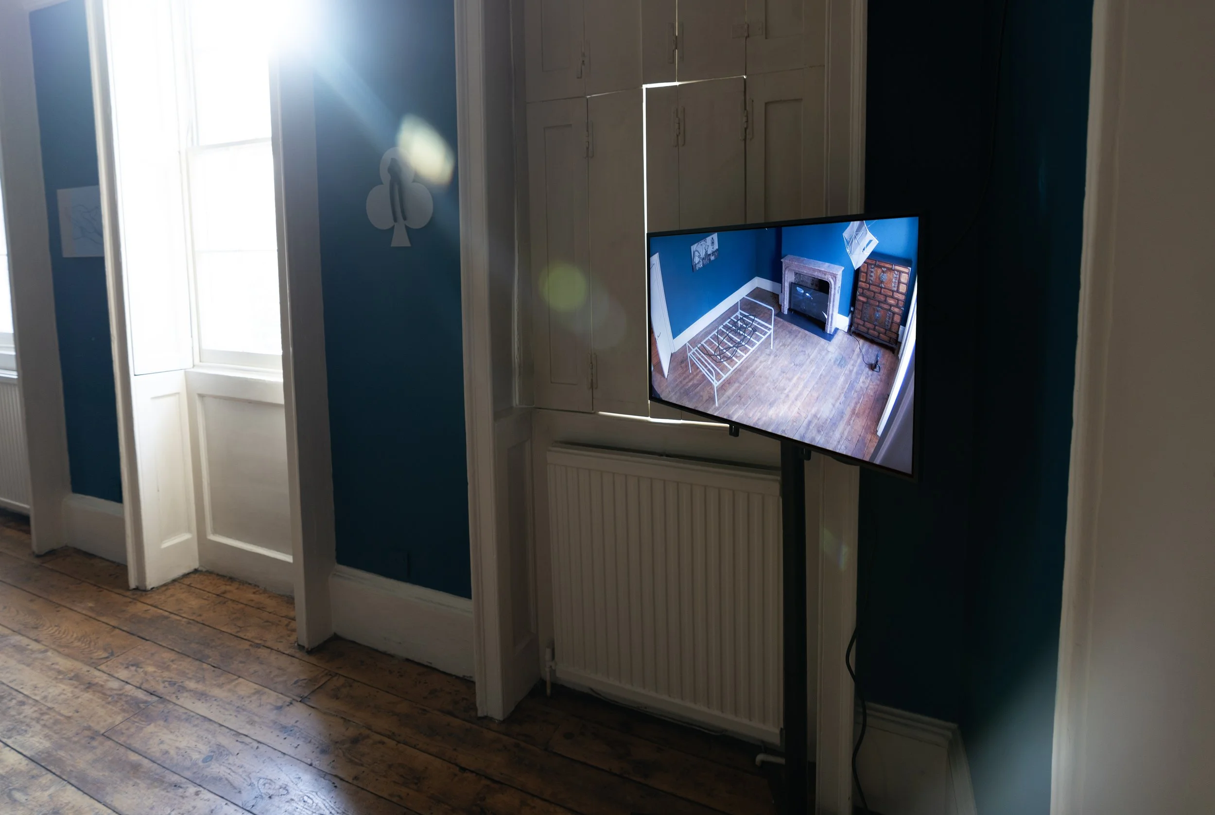 Propellers and Propositions (2024)
Vinyl, closed-circuit video camera, HD monitor. Floor section: H 330 x 183 cm, wall section: H 15 x 32 cm. Installation view Danielle Arnaud Gallery, London, 2024. © Ergin Çavuşoğlu.