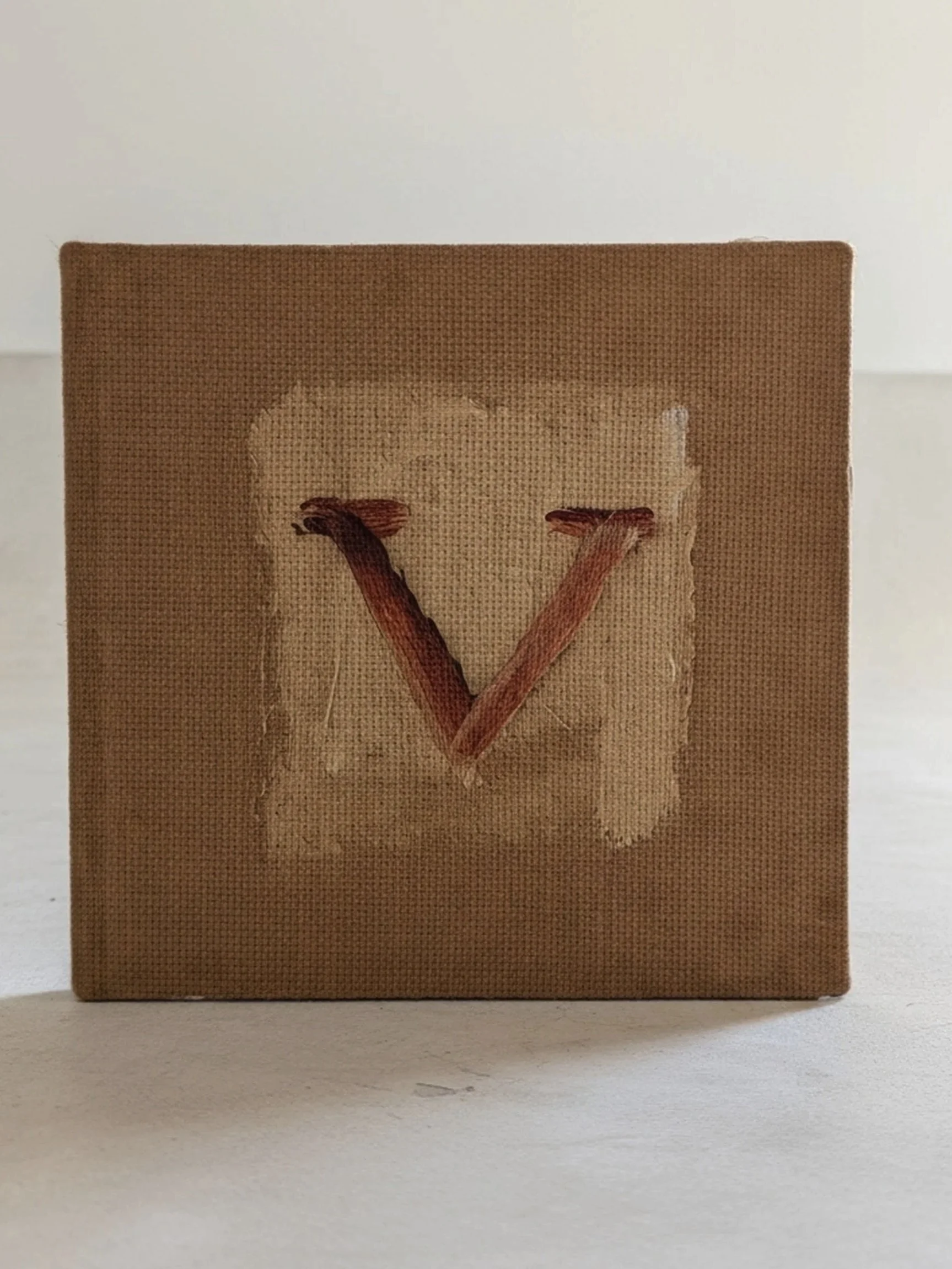 Red V for victory painted on a mottled canvas.jpg