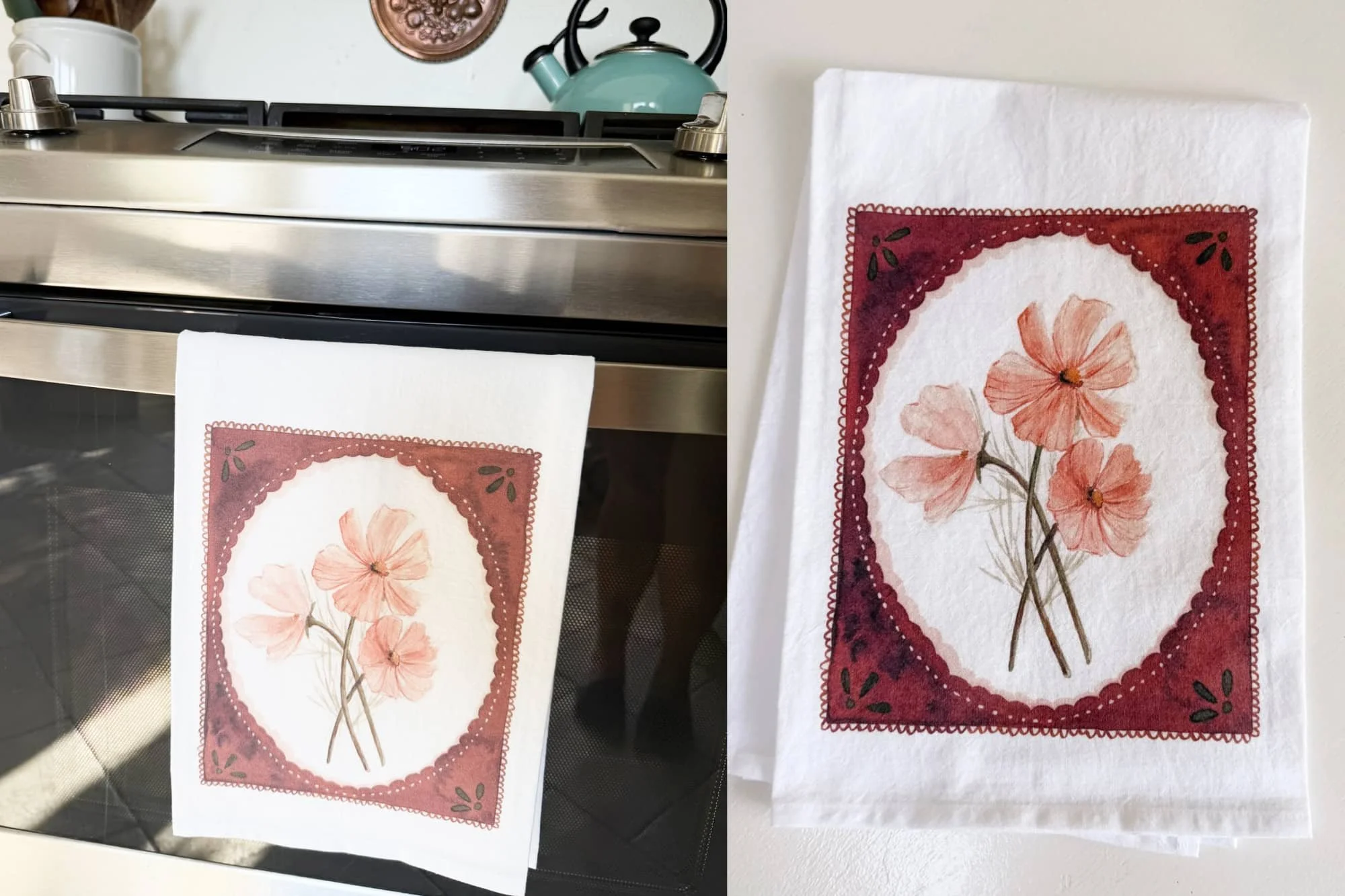 Hand-painted pink cosmos watercolor tea towel hanging on an oven handle in a kitchen, next to the same towel folded flat