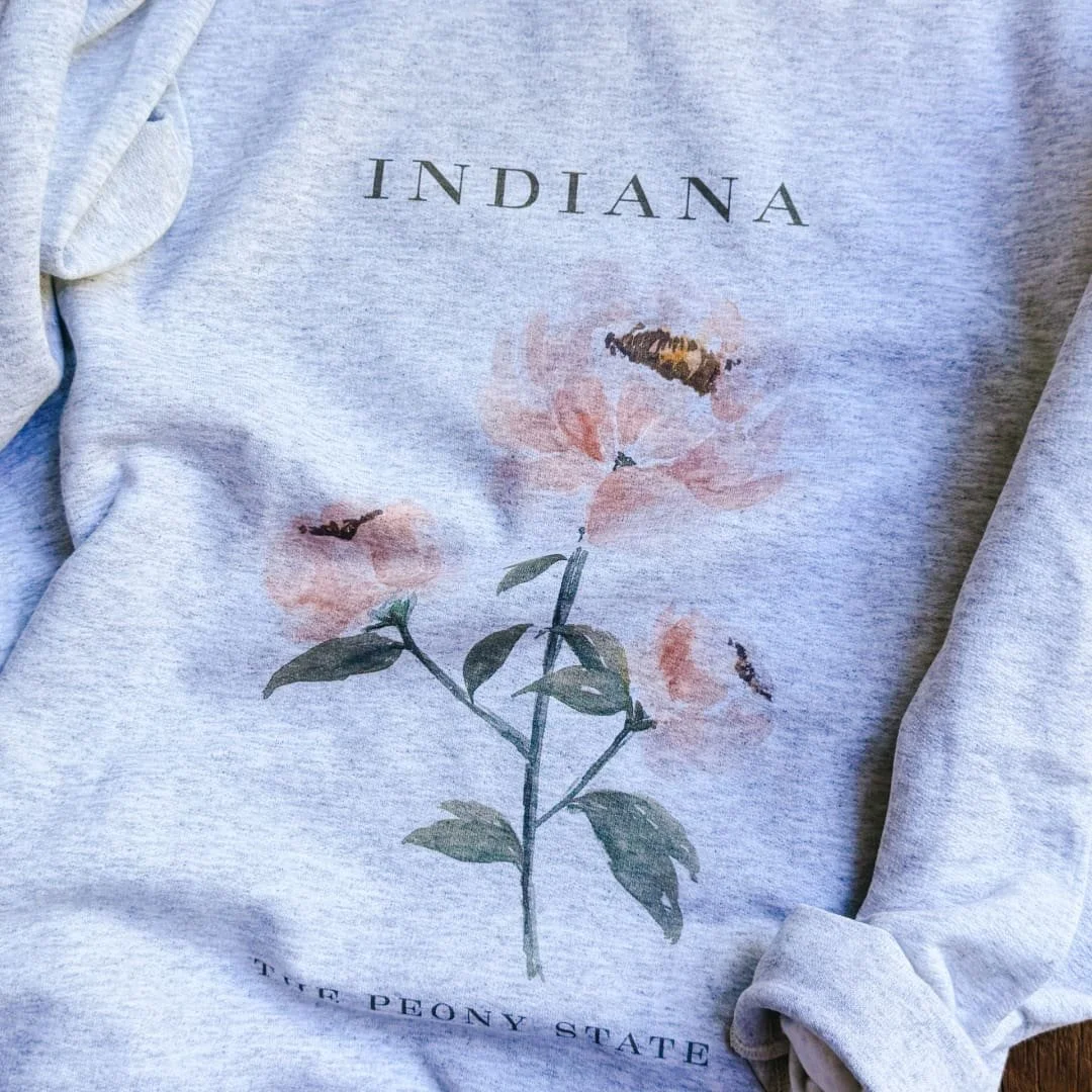 Close-up of the watercolor pink peony and INDIANA lettering on the ash gray crewneck sweatshirt