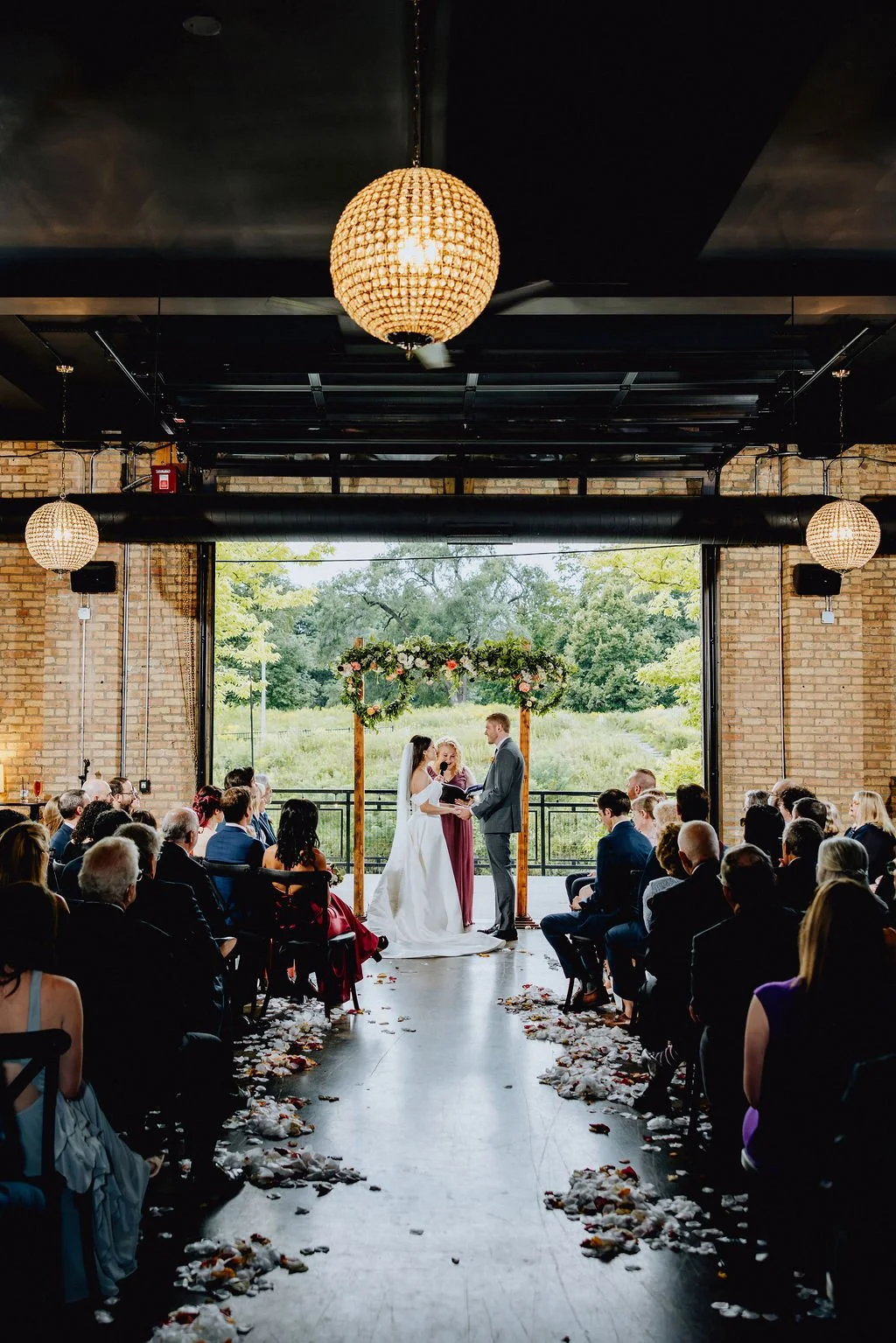 Bride and groom laugh during custom wedding ceremony with Chicago officiant Forever Incredible at The River Room at Burning Bush Brewery